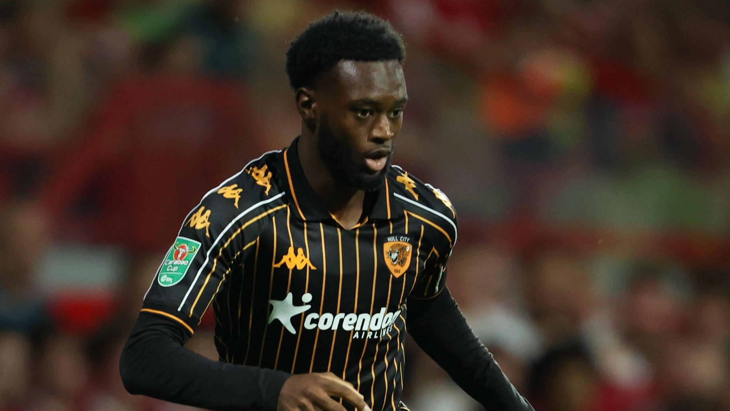 Abu Kamara playing for Hull (in their away kit) at Wrexham in a Carabao Cup tie