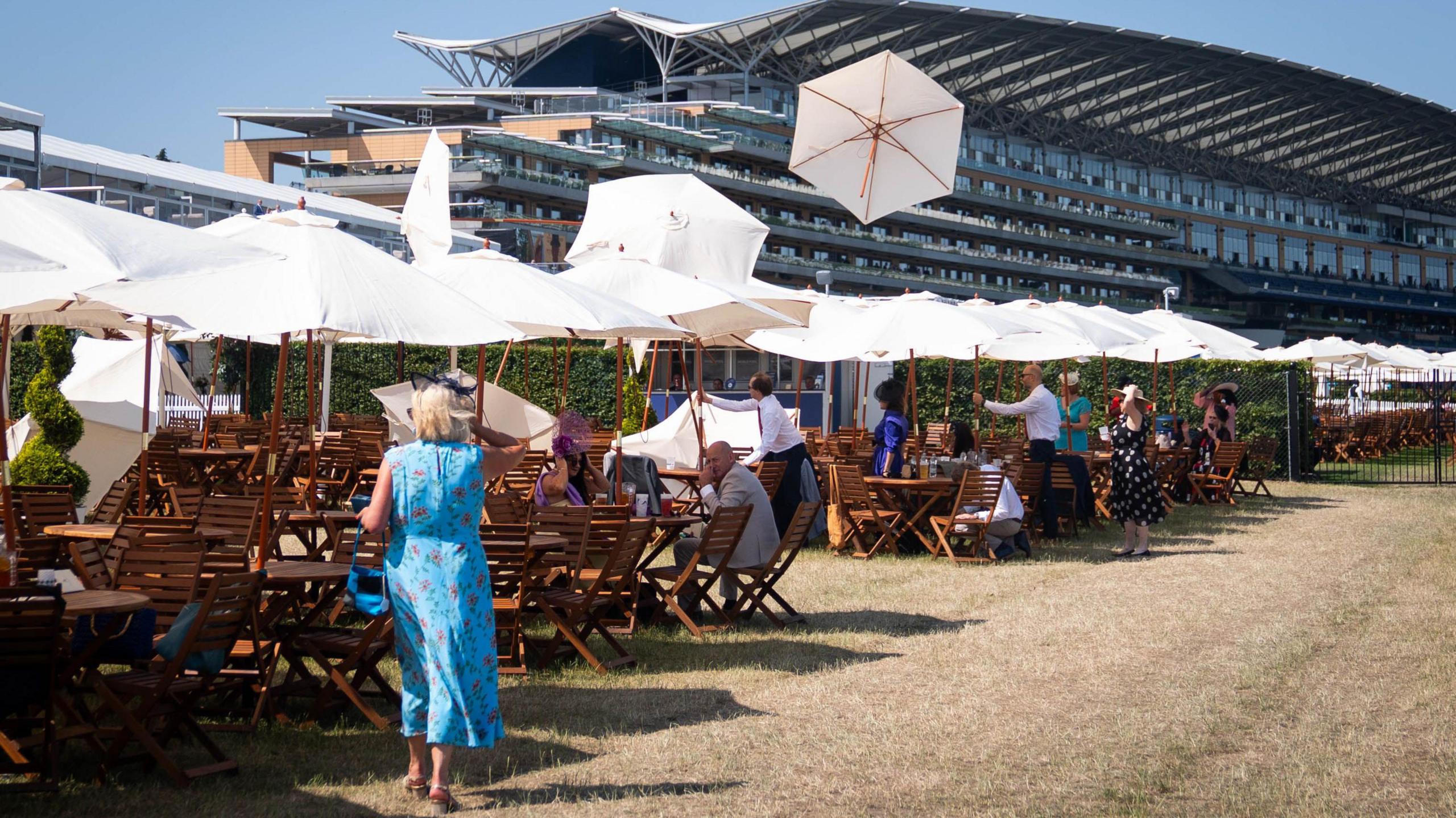 Umbrellas blown away by a gust of wind on day three of Royal Ascot at Ascot Racecourse, Berkshire. 
