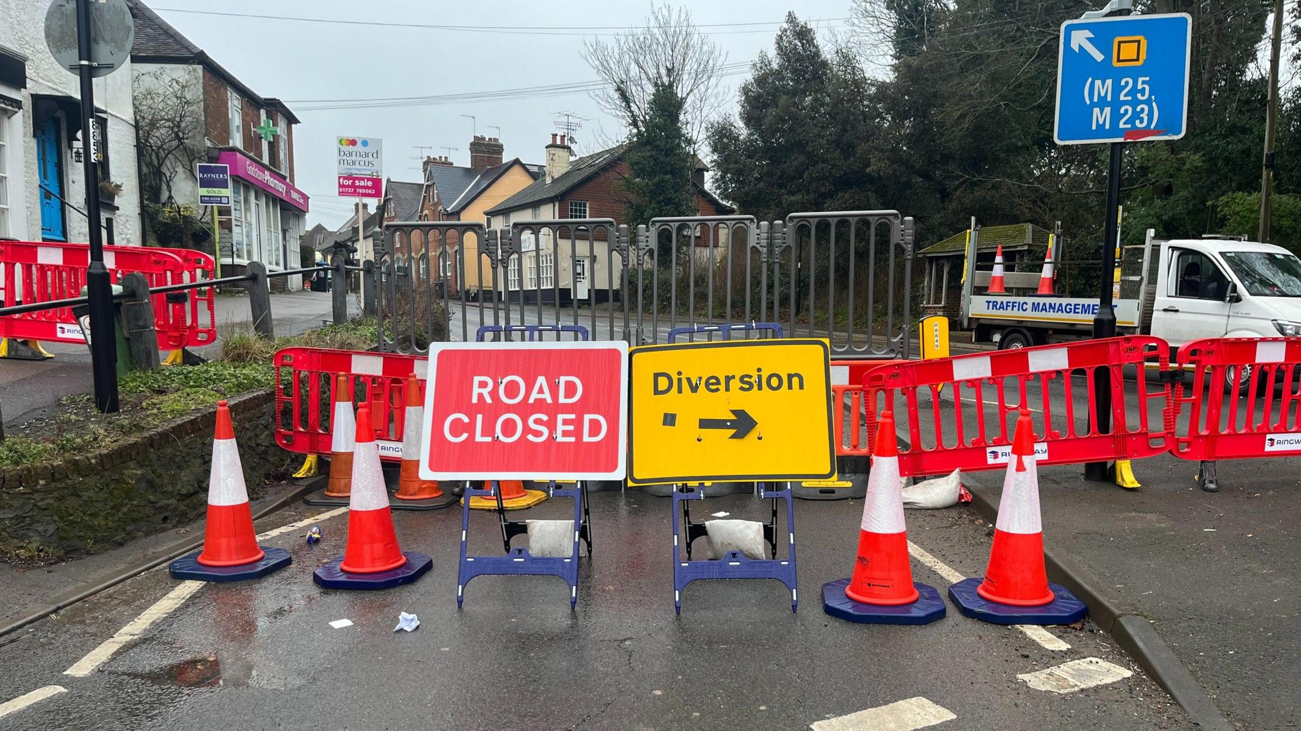 A set of road barriers and a diversion sign in the centre of Godstone.