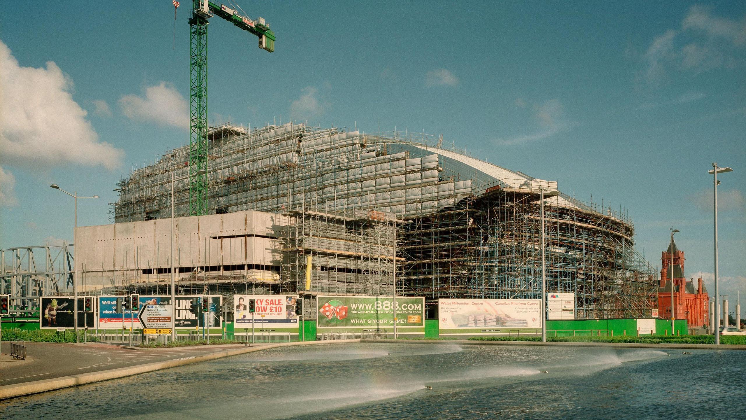 A half-built Wales Millennium Centre, clad with scaffolding.