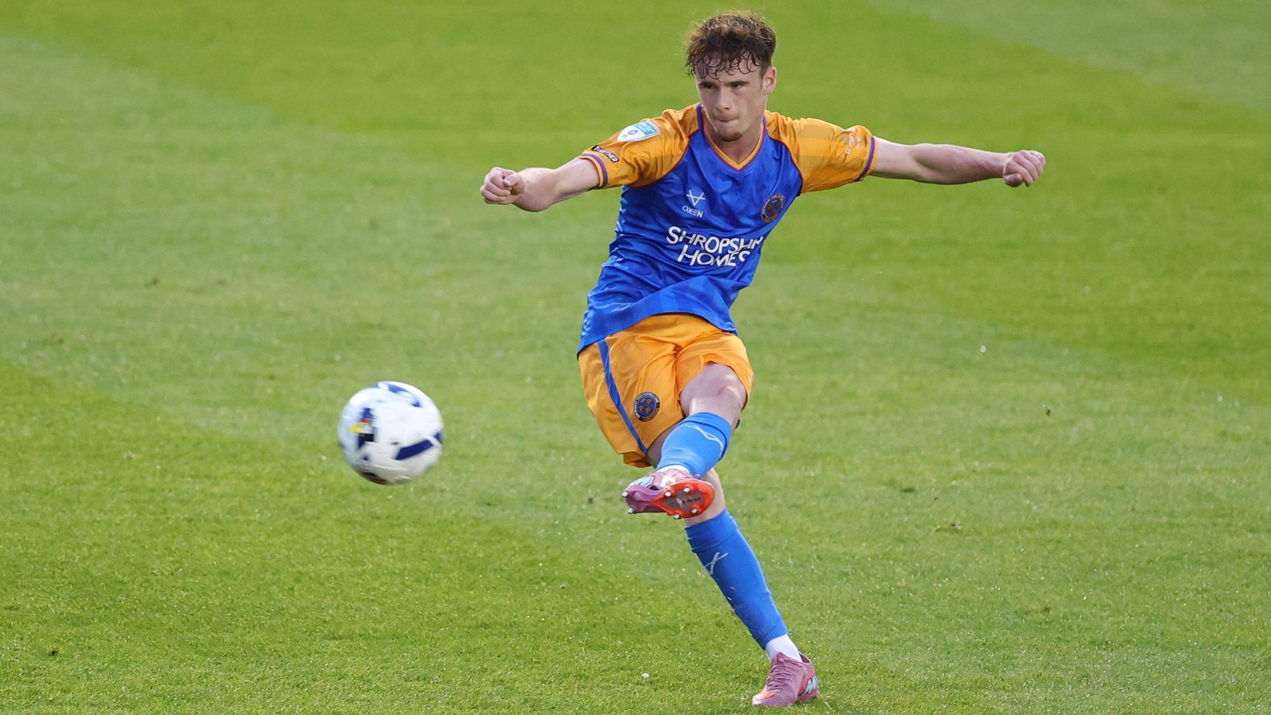 Tommy McDermott whips in a left-footed free-kick during a match for Shrewsbury