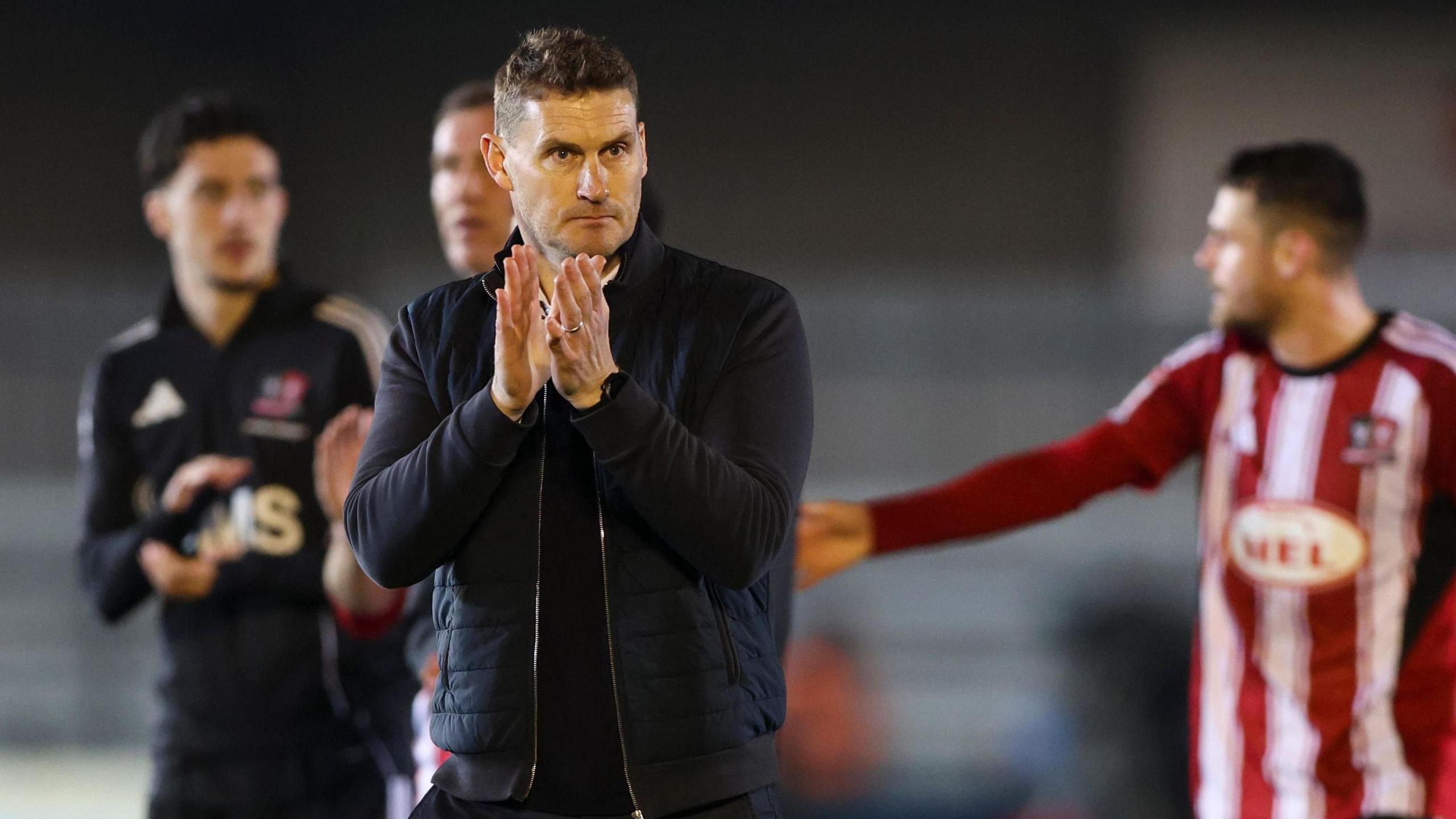 Matt Taylor claps supporters after Exeter's draw against Burton