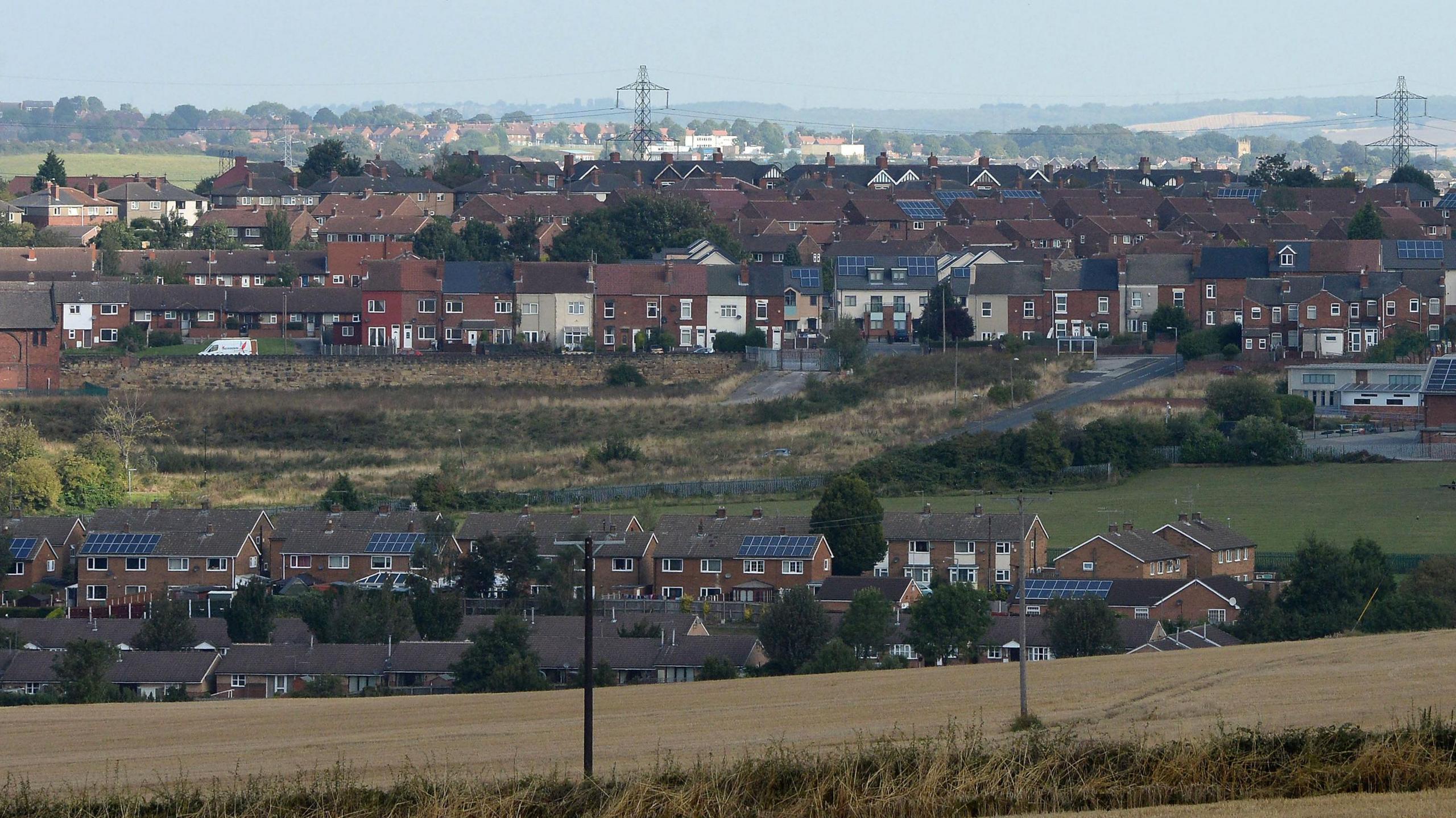 A scene setter view of Rotherham, featuring rows of houses interspersed with fields        