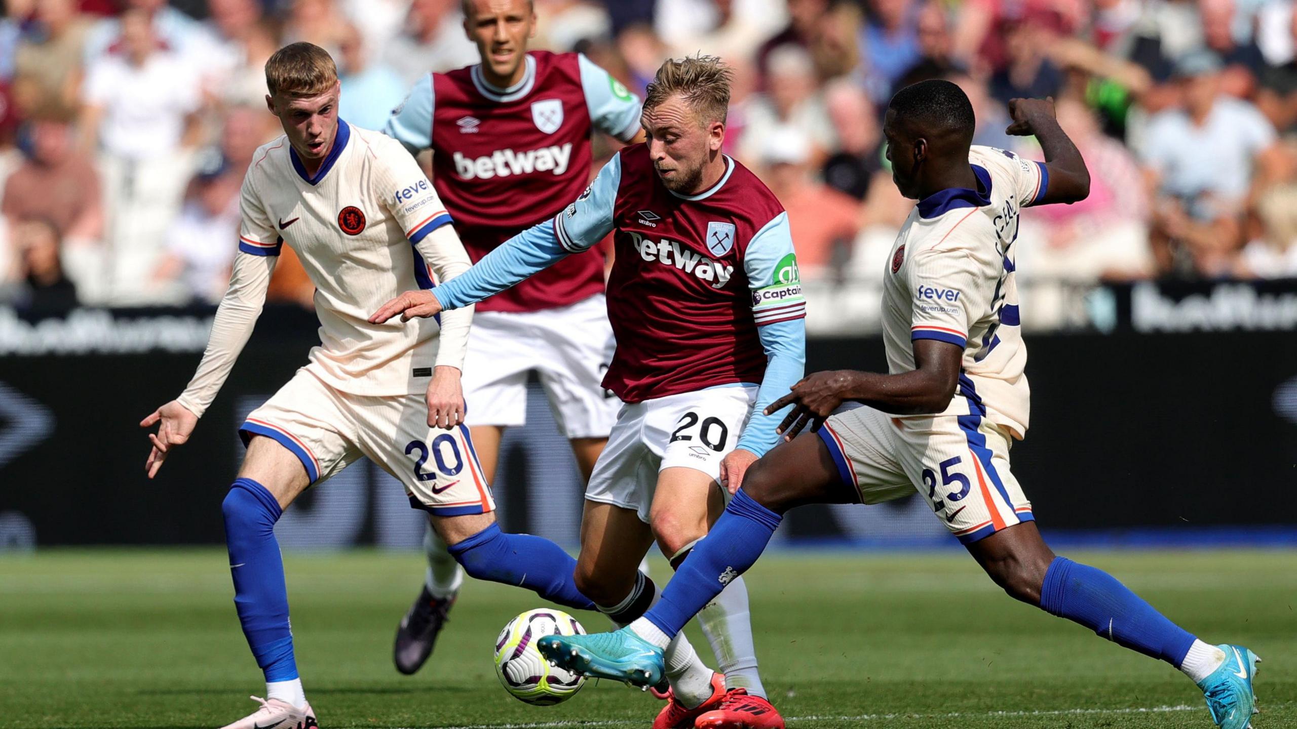 Moises Caicedo (right) and Cole Palmer (left) challenge West Ham's Jarrod Bowen during Chelsea's 3-0 win over the Hammers in September