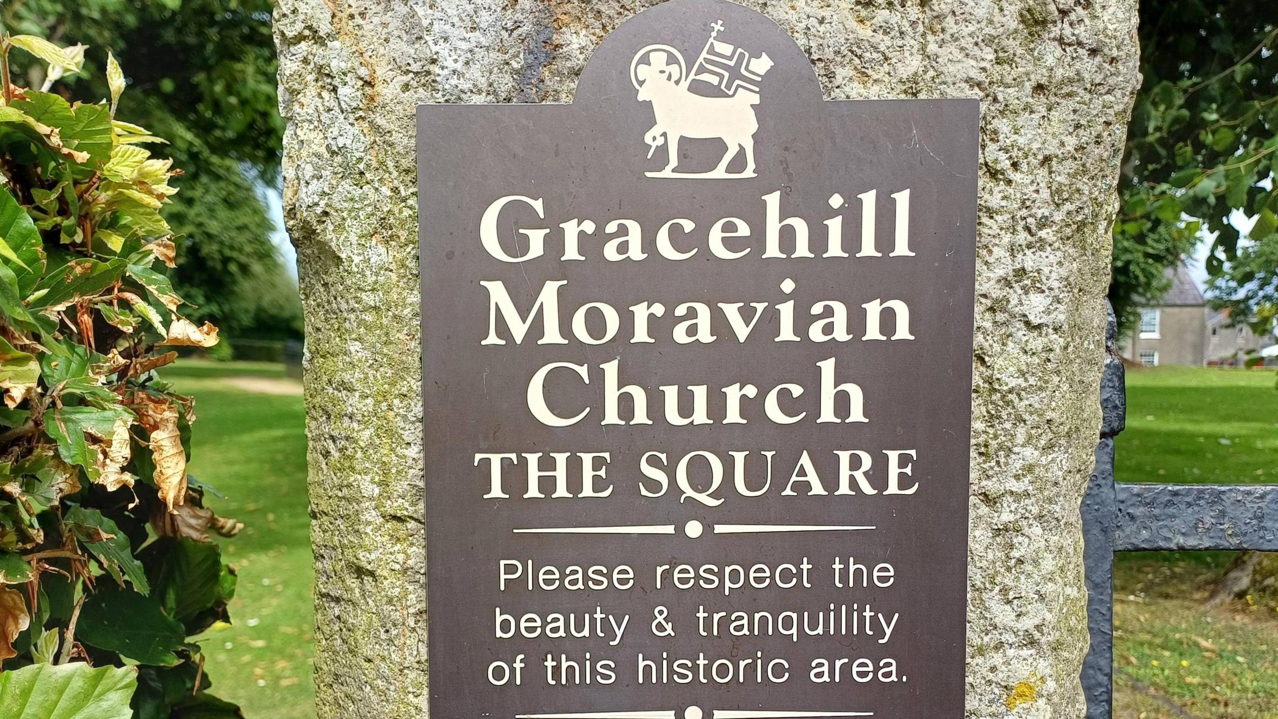 Sign saying Gracehill Moravian Church. The Square. Please respect the beauty and tranquillity of this historic area