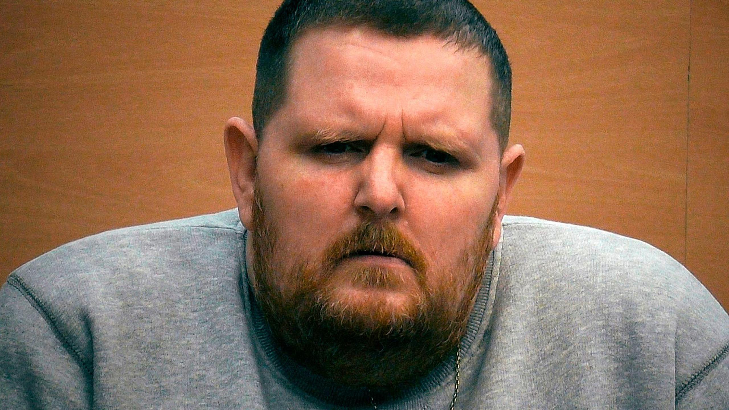 Photo of Robbie O'Brien. He is now about 45. He wears a grey sweatshirt. He has short black hair and beard which seems to have a shade of ginger. 