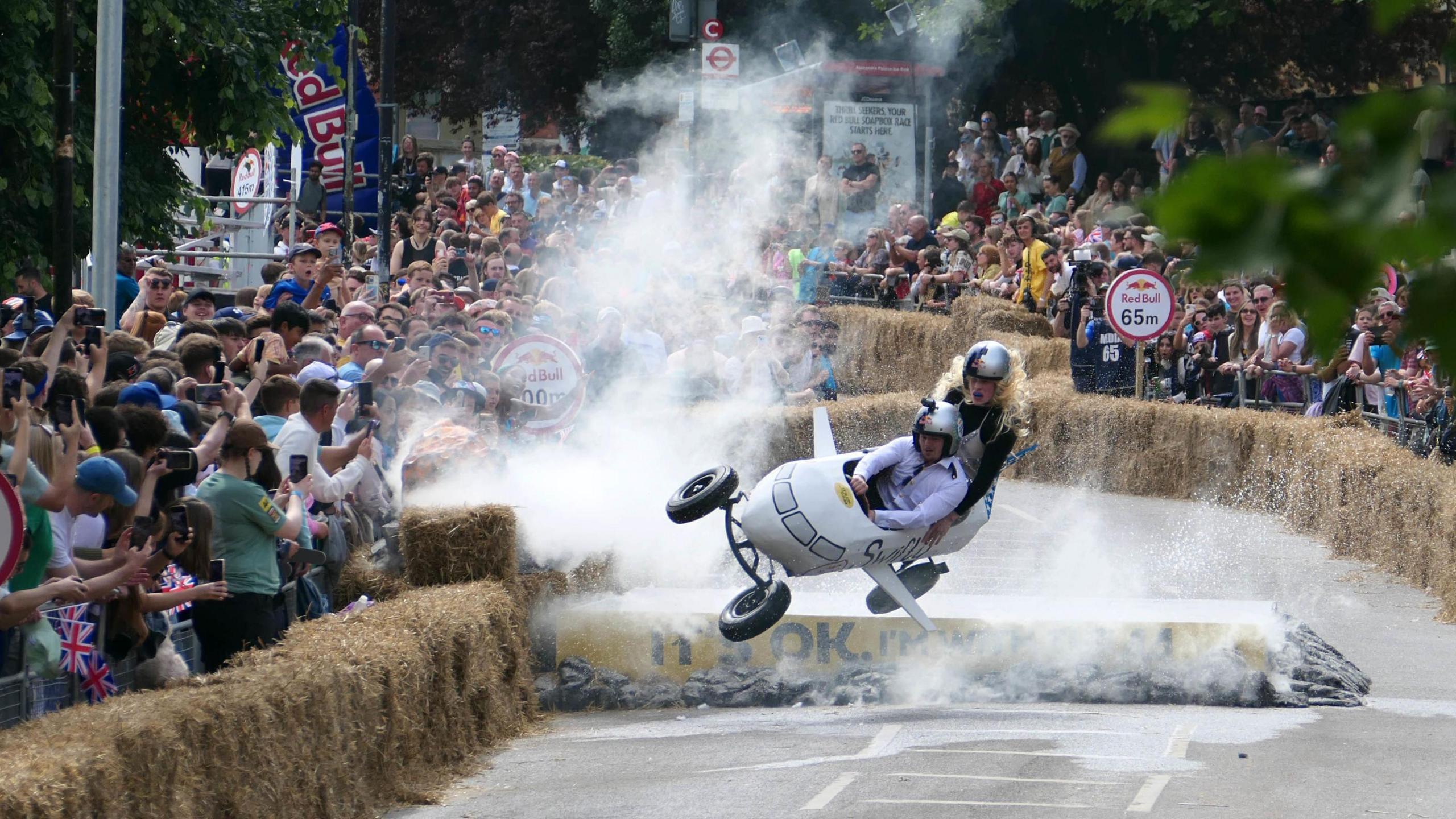 A homemade cart in the shape of an aeroplane flies through the air at the Red Bull Soapbox Races