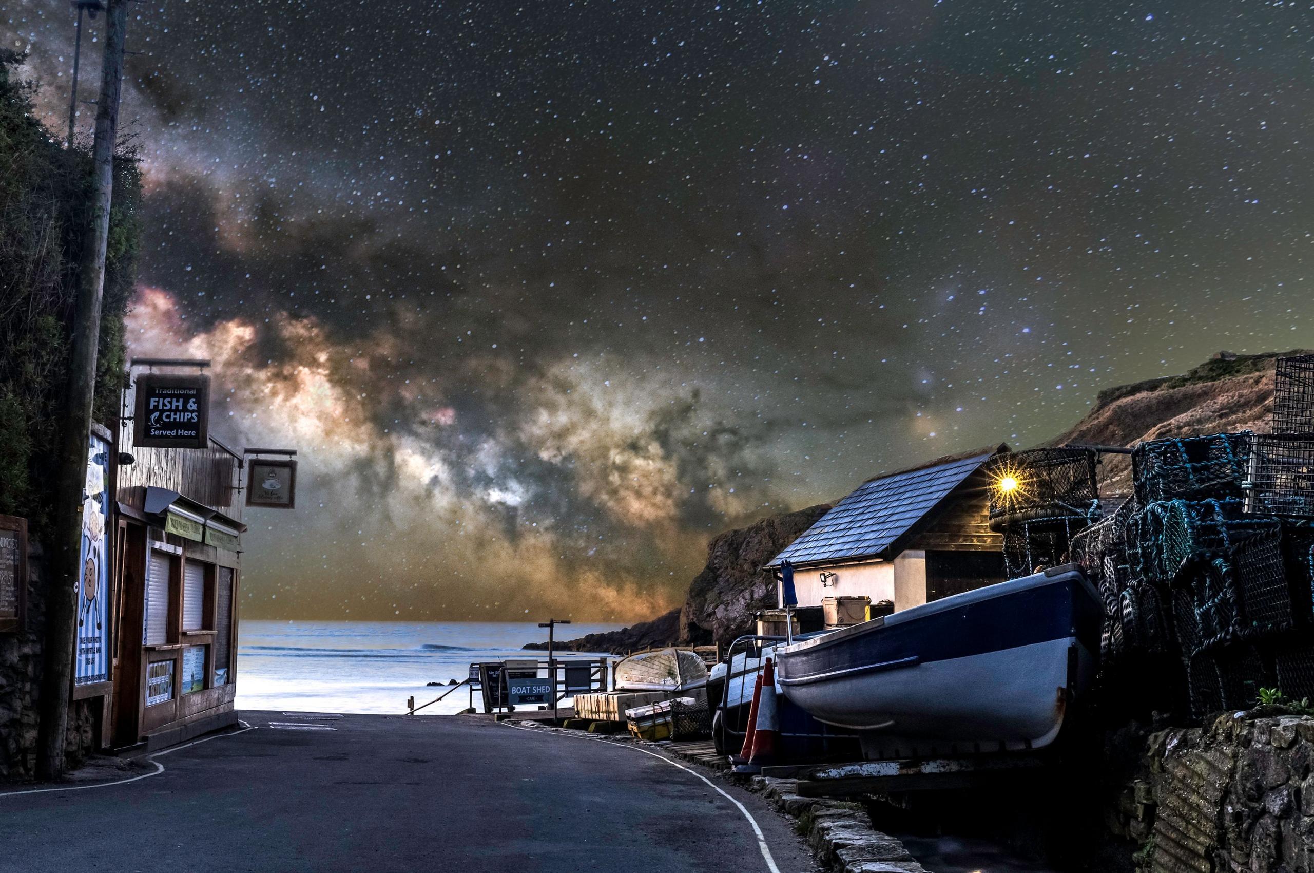 The Milky Way arcs over Lulworth Cove.