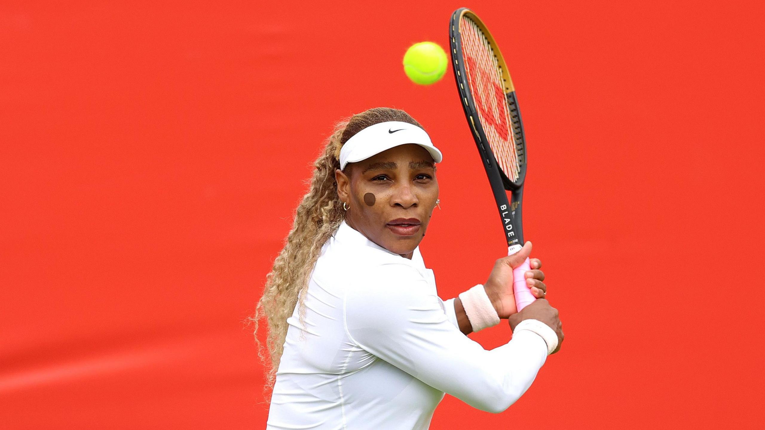 Serena Williams hits a return during practice at Queen's