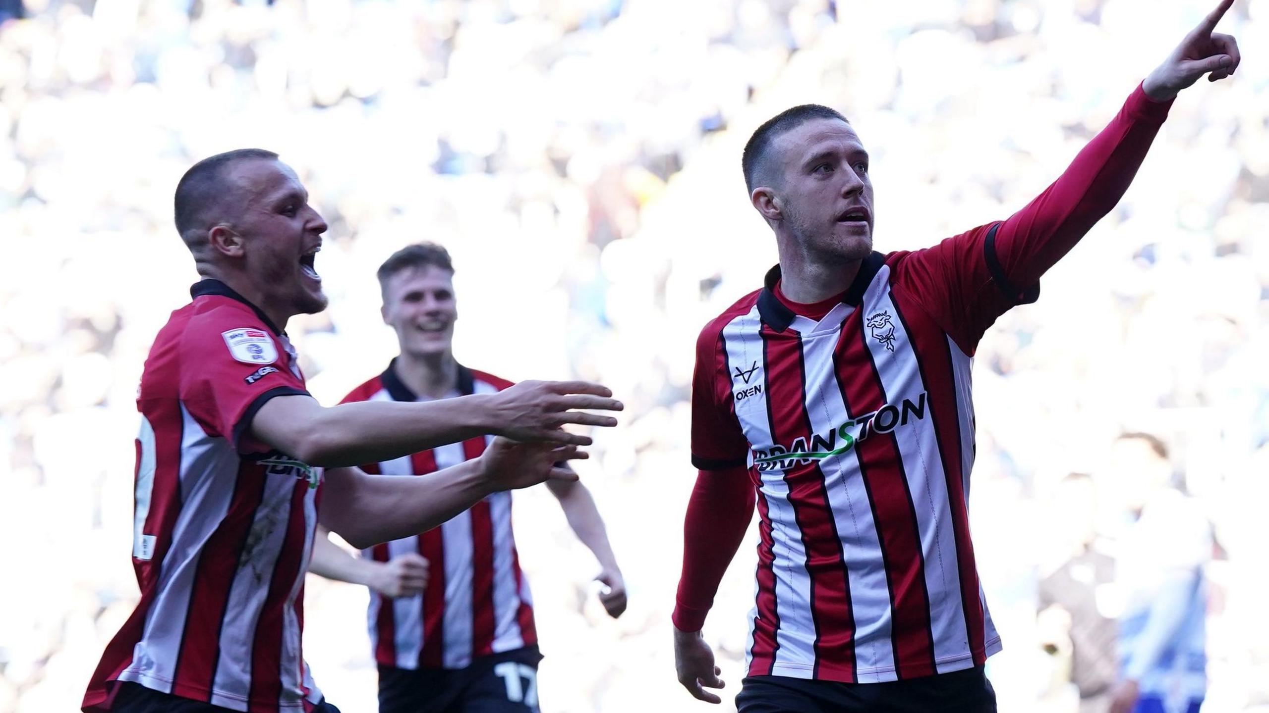 Jack Moylan (right) celebrates scoring for Lincoln in their promotion-clinching game against Reading
