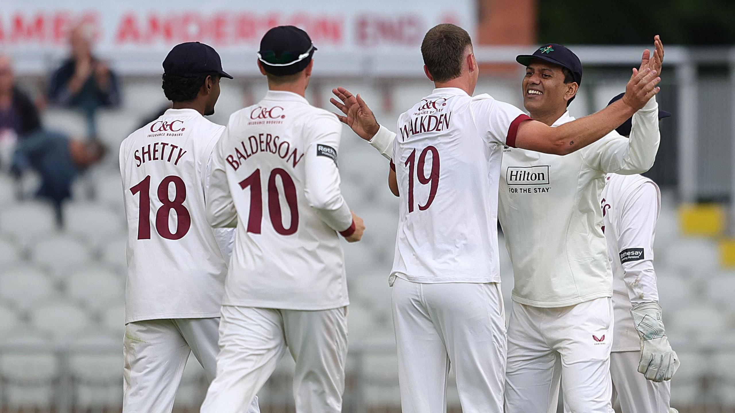 Ben Walkden (WALKDEN 19) is congratulated on his first Lancashire wicket