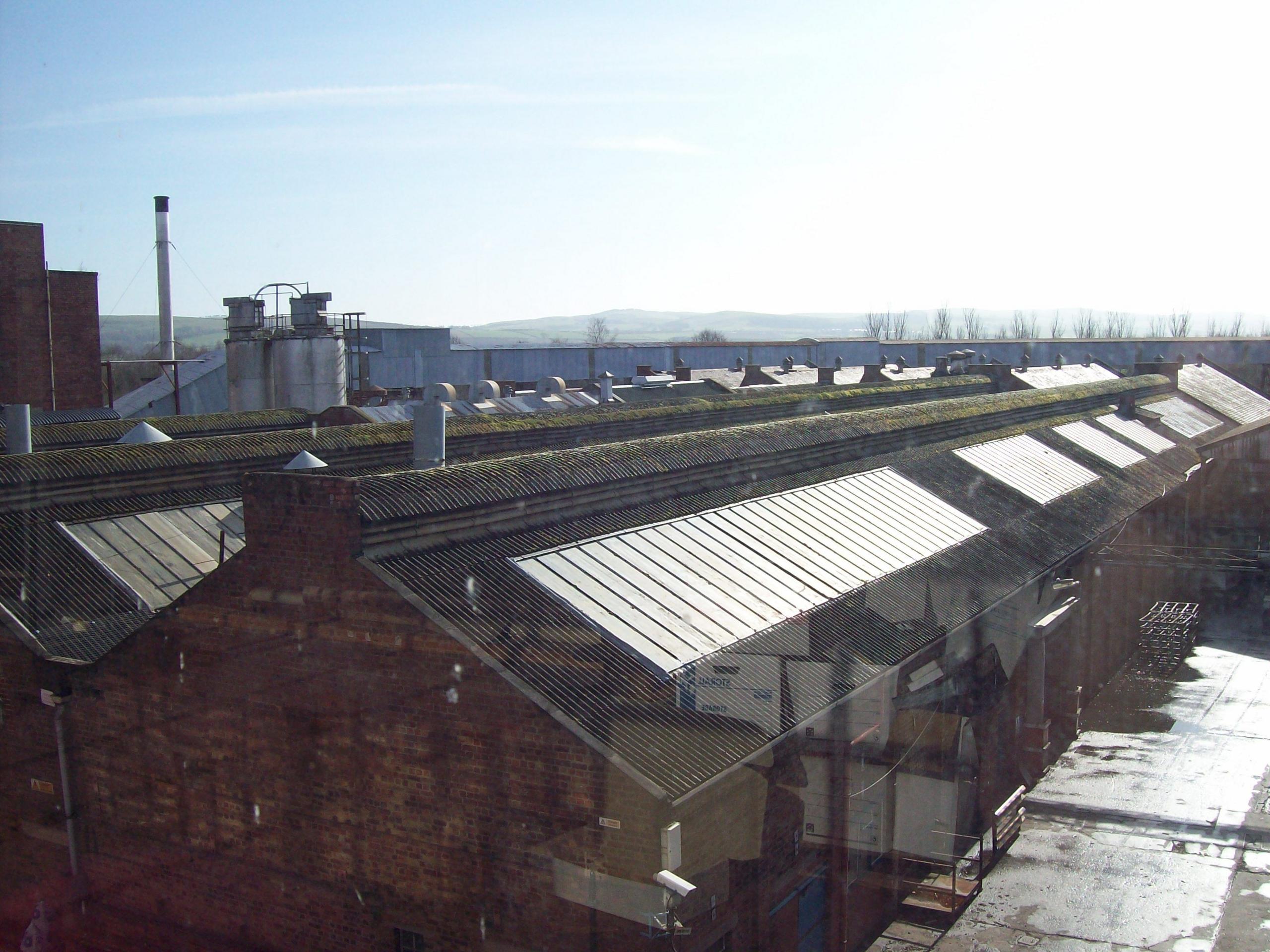 A rooftop of an old factory building looking out into the distance