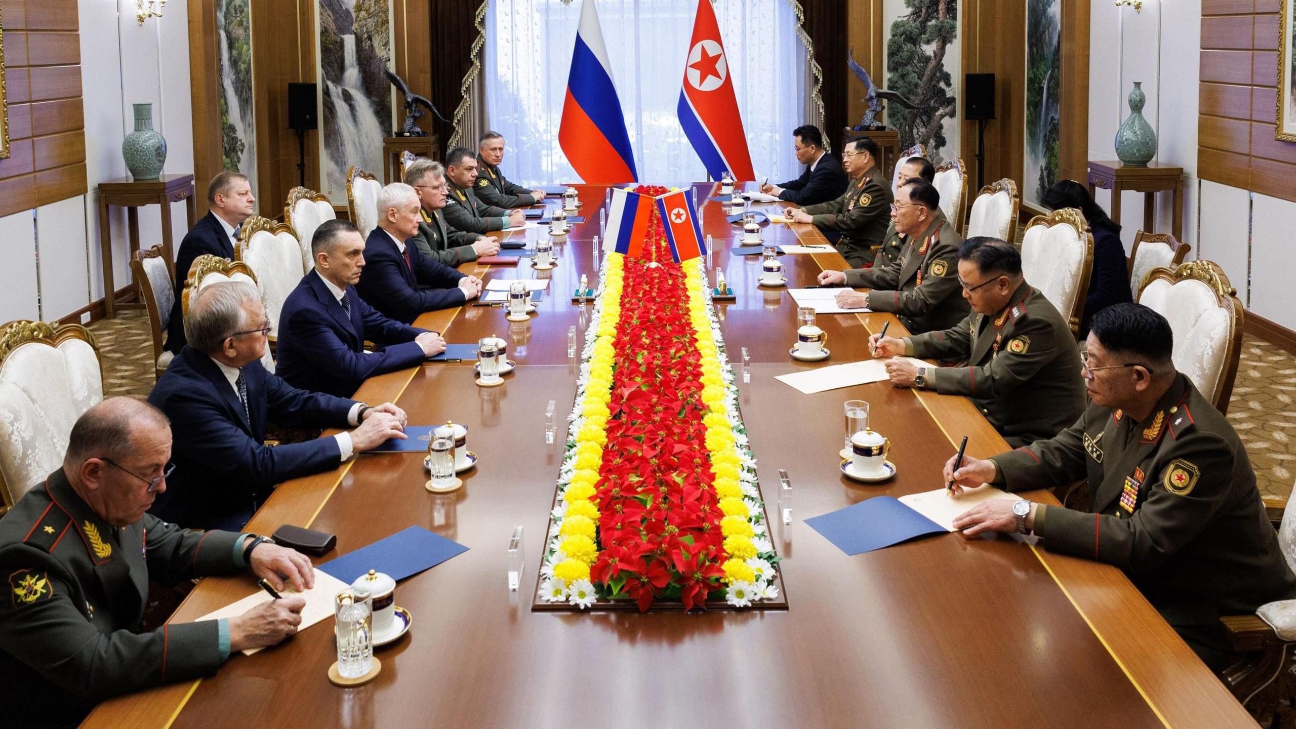 Russian Defence Ministry delegation led by Minister Andrey Belousov (fourth on left), sit at table facing North Korean counterparts (on right) at talks in Pyongyang, 29 November