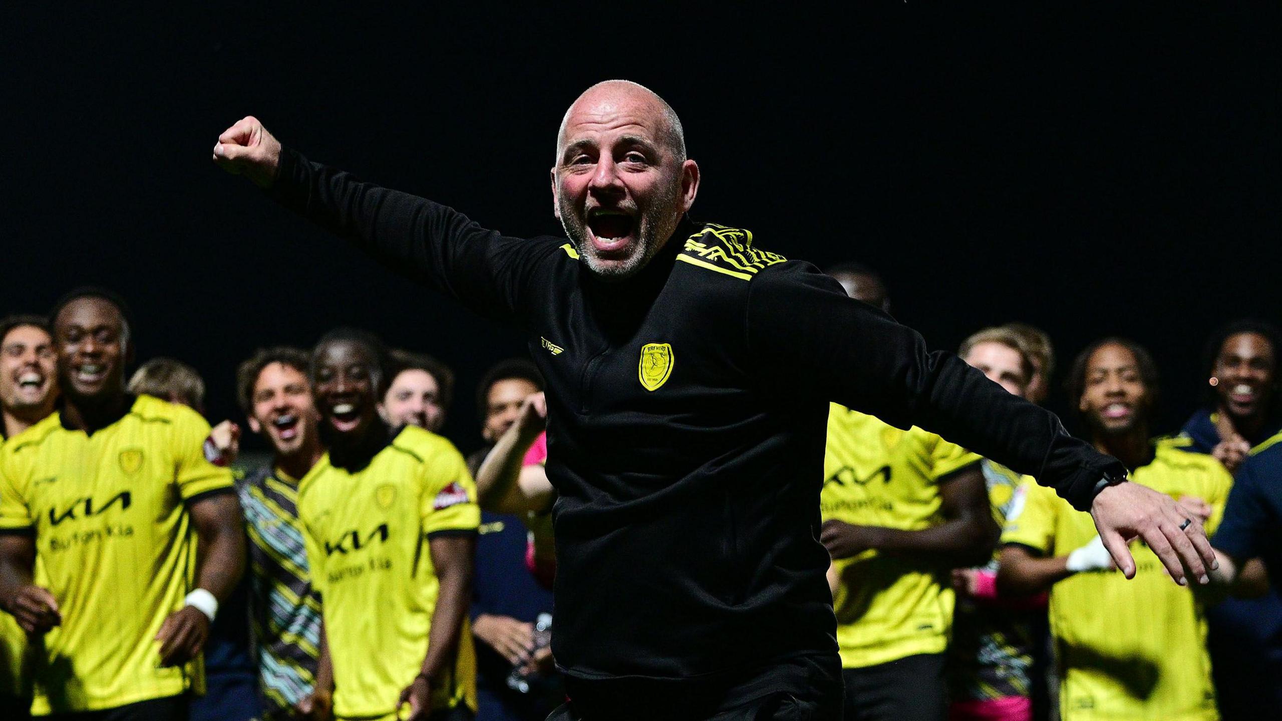 Pat Lyons celebrating with Burton players after they avoided relegation