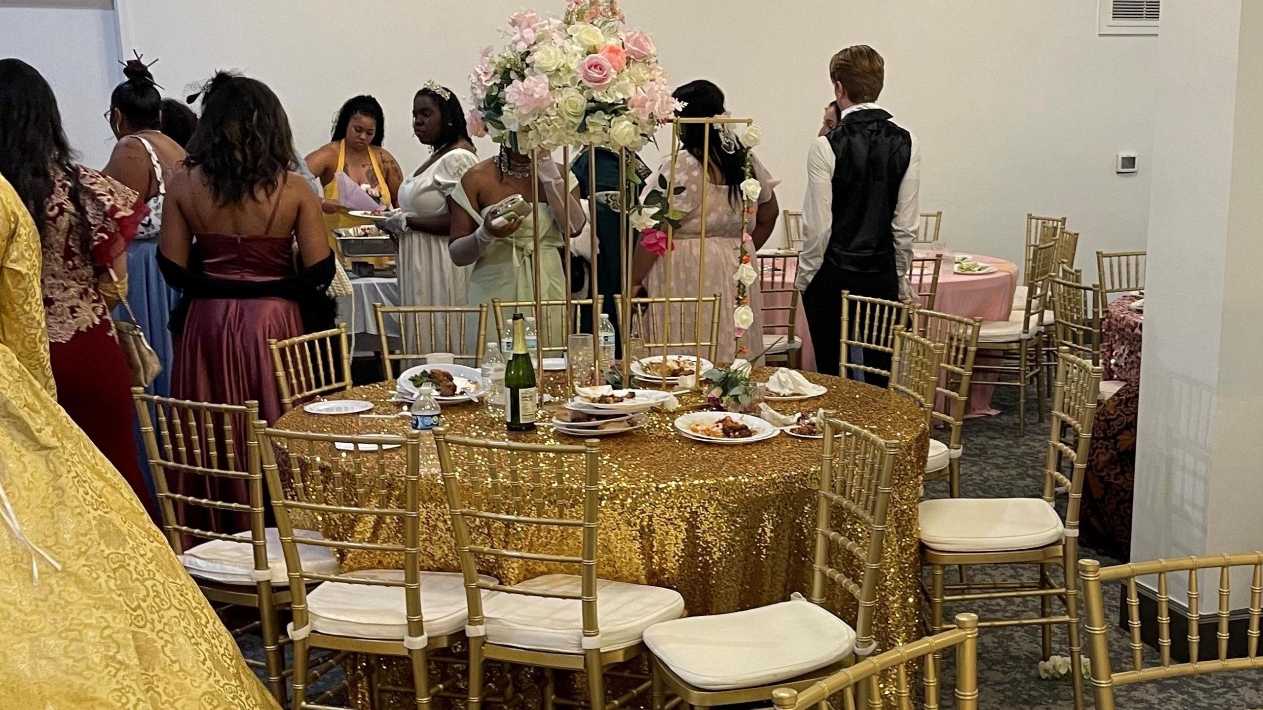 A picture of people in ballgowns and dining tables at the unofficial Bridgerton ball in Detroit