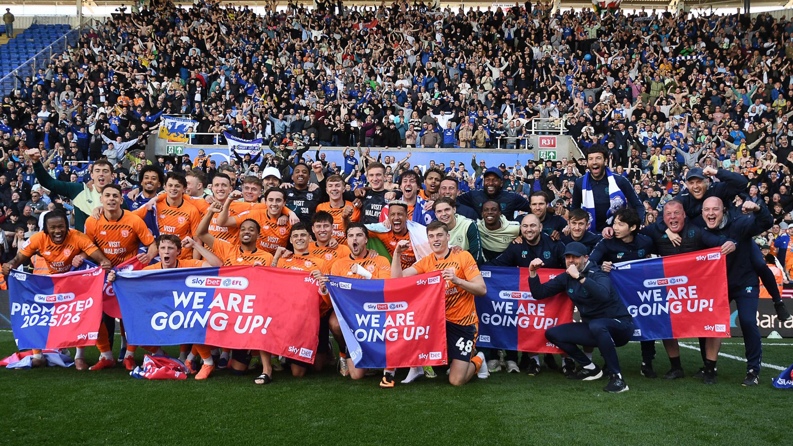 Cardiff City players and staff celebrate promotion in front of their fans