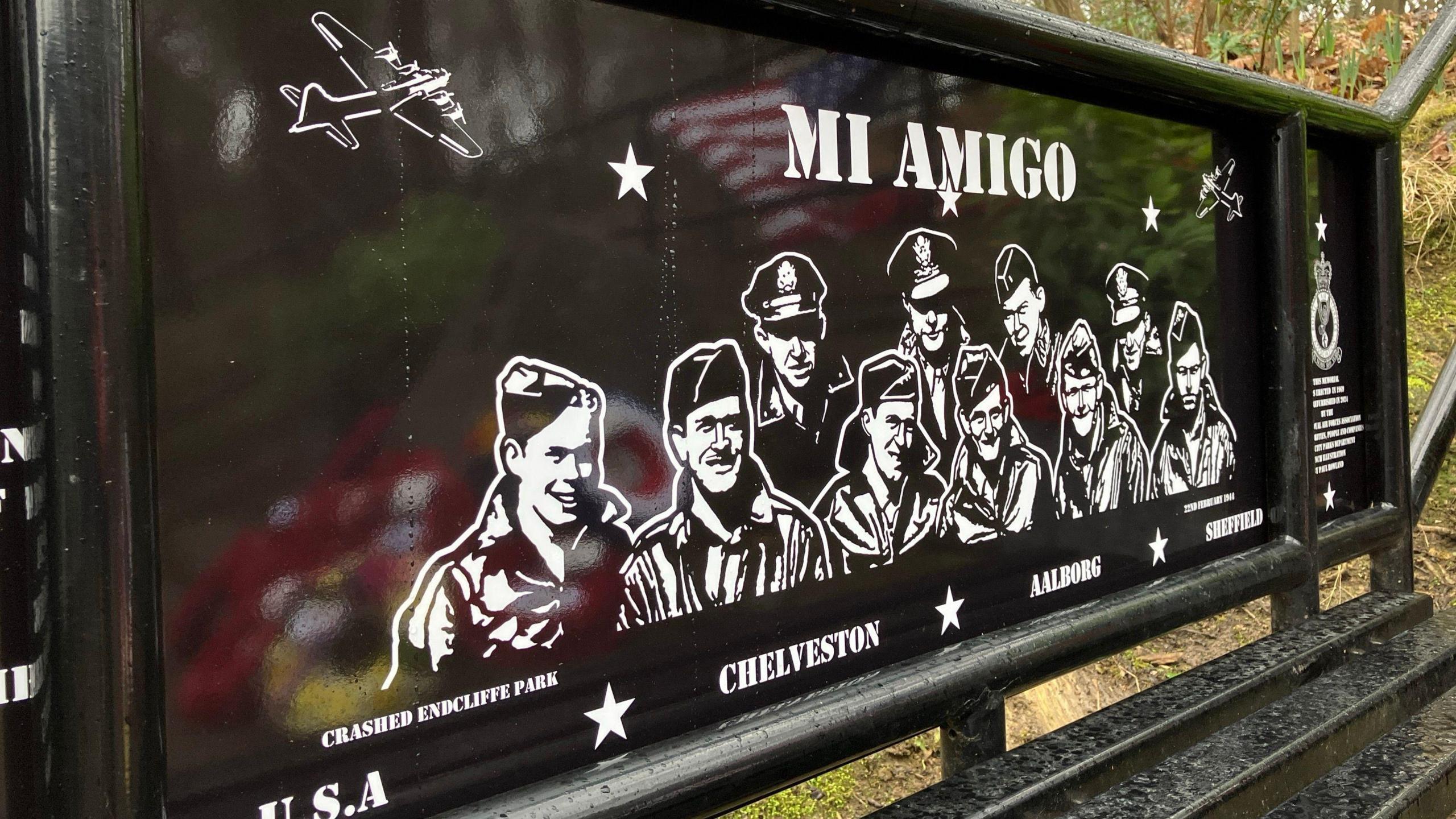 A sign showing the victims of the Mi Amigo plane crash, drawn in black and white on the backrest of the bench. 