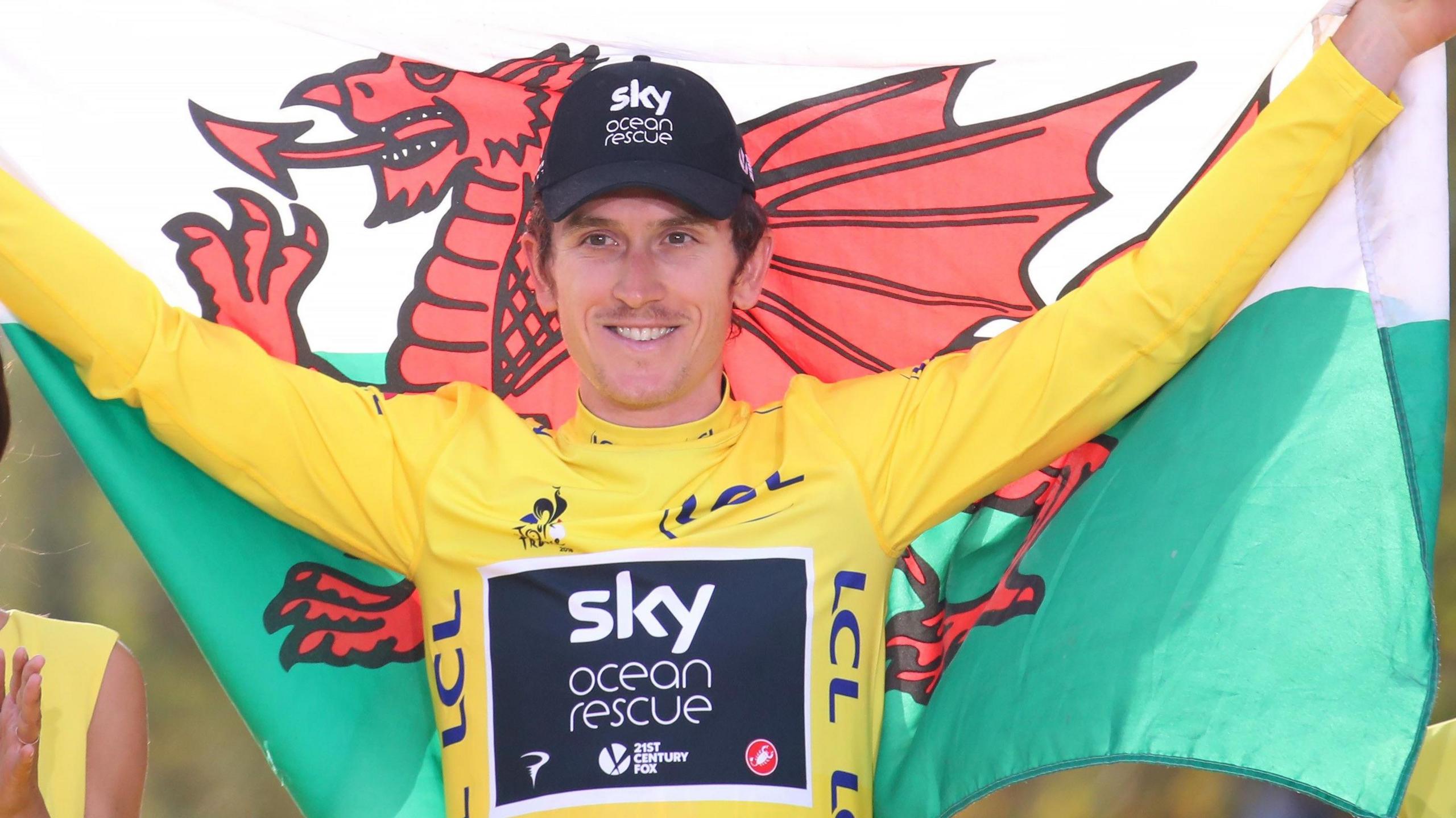 Geraint Thomas holds nan Welsh emblem aft winning nan 2018 Tour de France