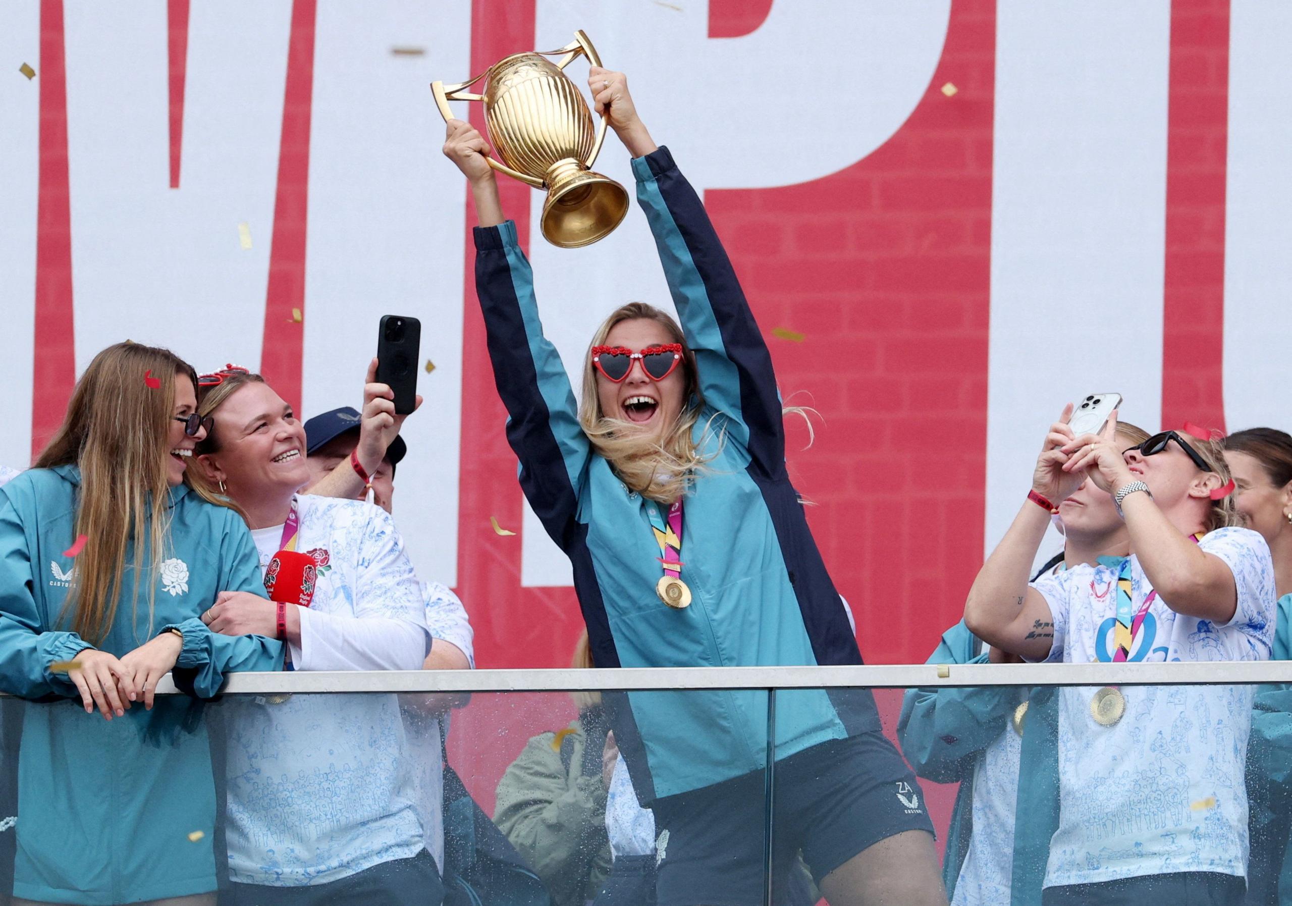 England's Zoe Aldcroft celebrates with the trophy in front of the fans during a Champions Party at Battersea Power Station, London.