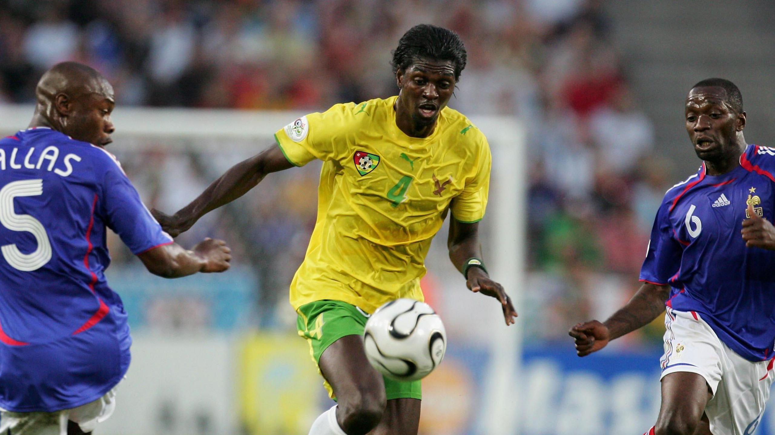 Togo striker Emmanuel Adebayor attempts to controls a ball while looking to evade the attention of France players William Gallas and Claude Makelele