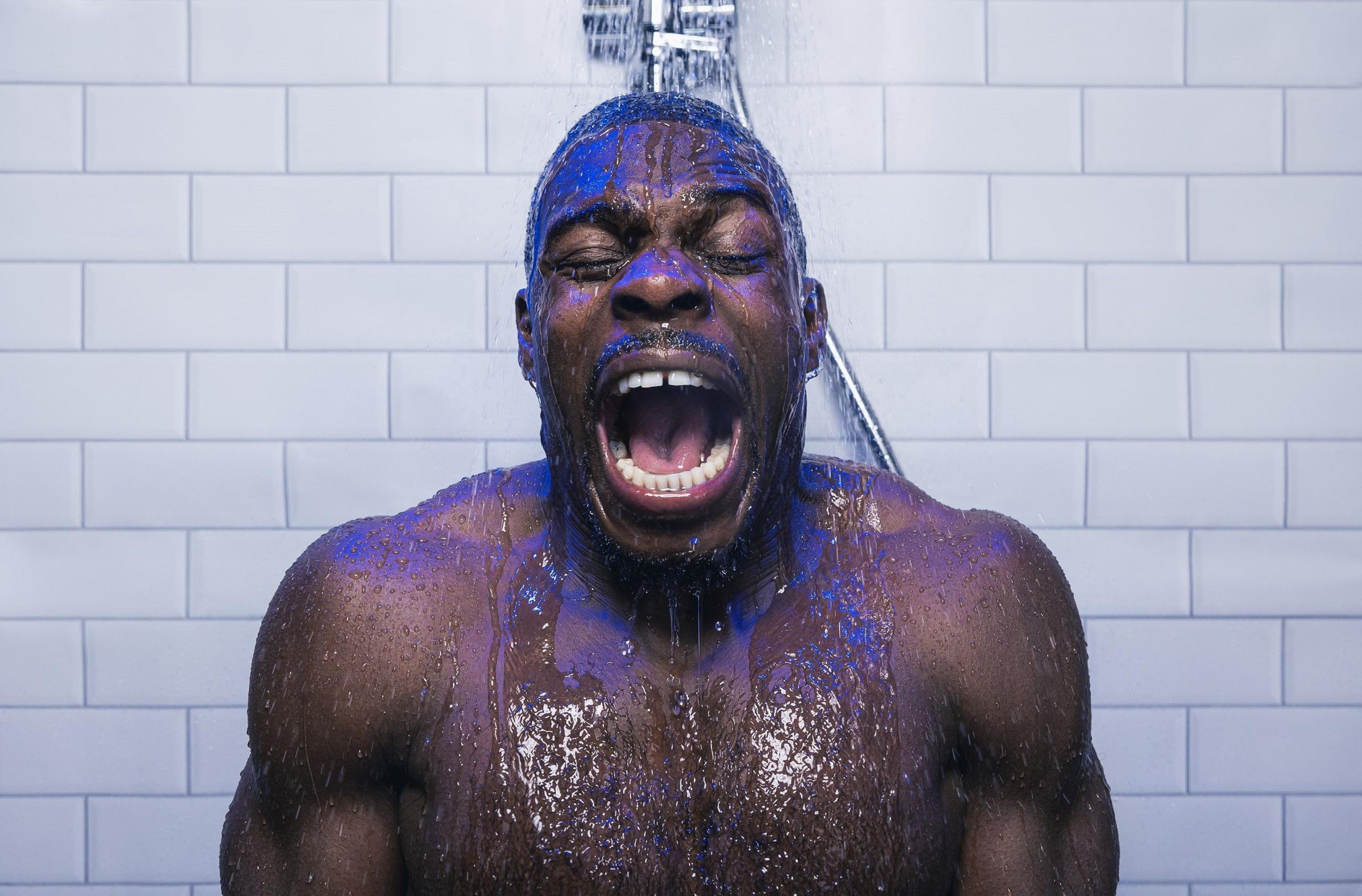 Gloucester rugby player Christian Wade grimaces as he stands under a cold shower