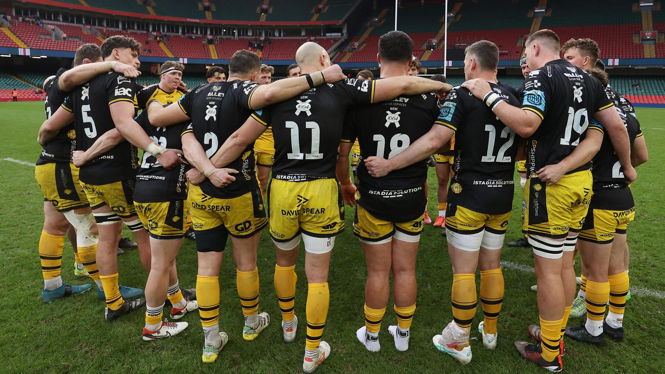 Dragons players successful a huddle astatine Principality Stadium
