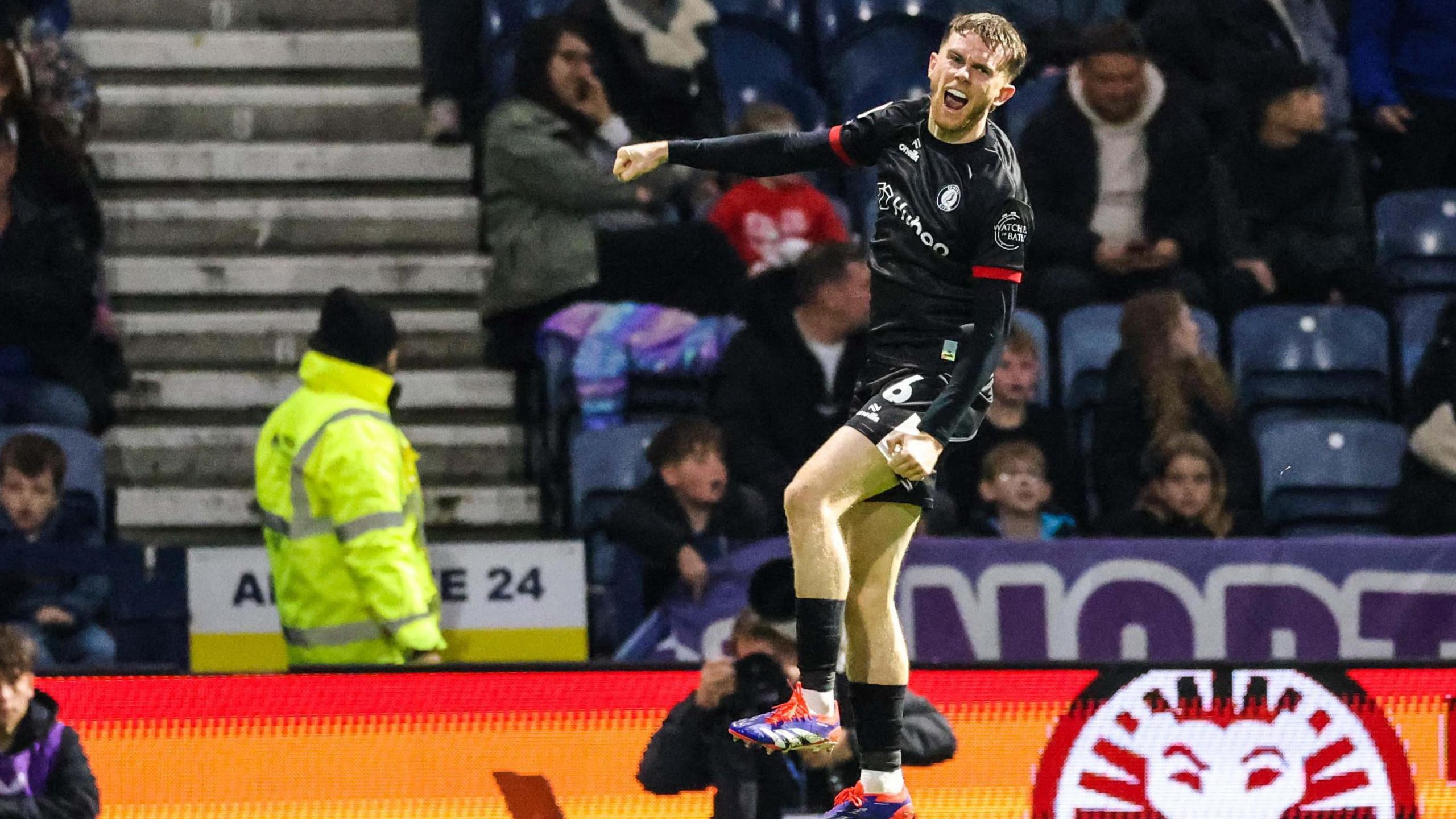 Max Bird leaps into the air after scoring Bristol City's third goal at Preston