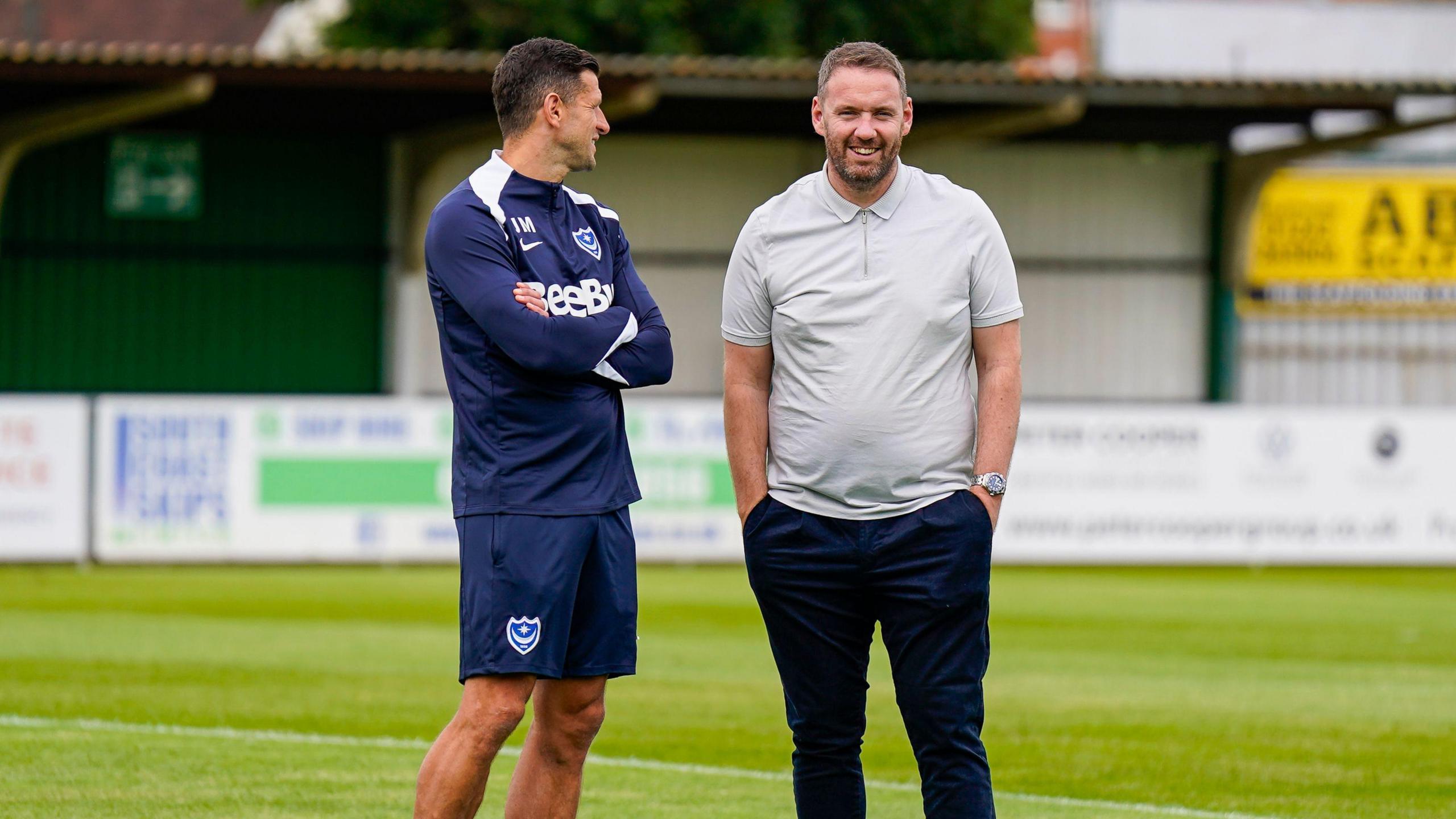 Portsmouth head coach John Mousinho in discussion with sporting director Richard Hughes