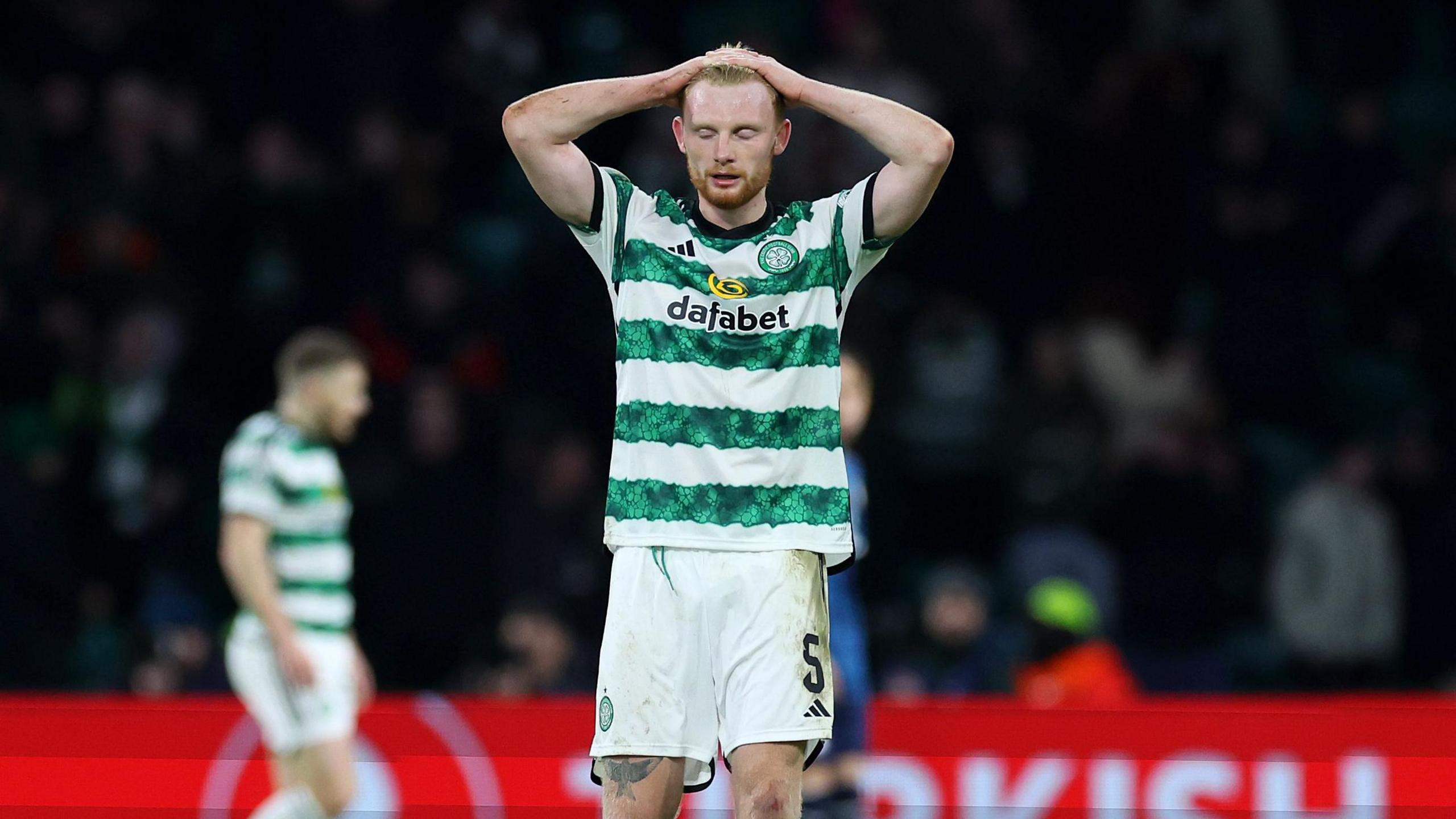 Celtic defender Liam Scales looks dejected