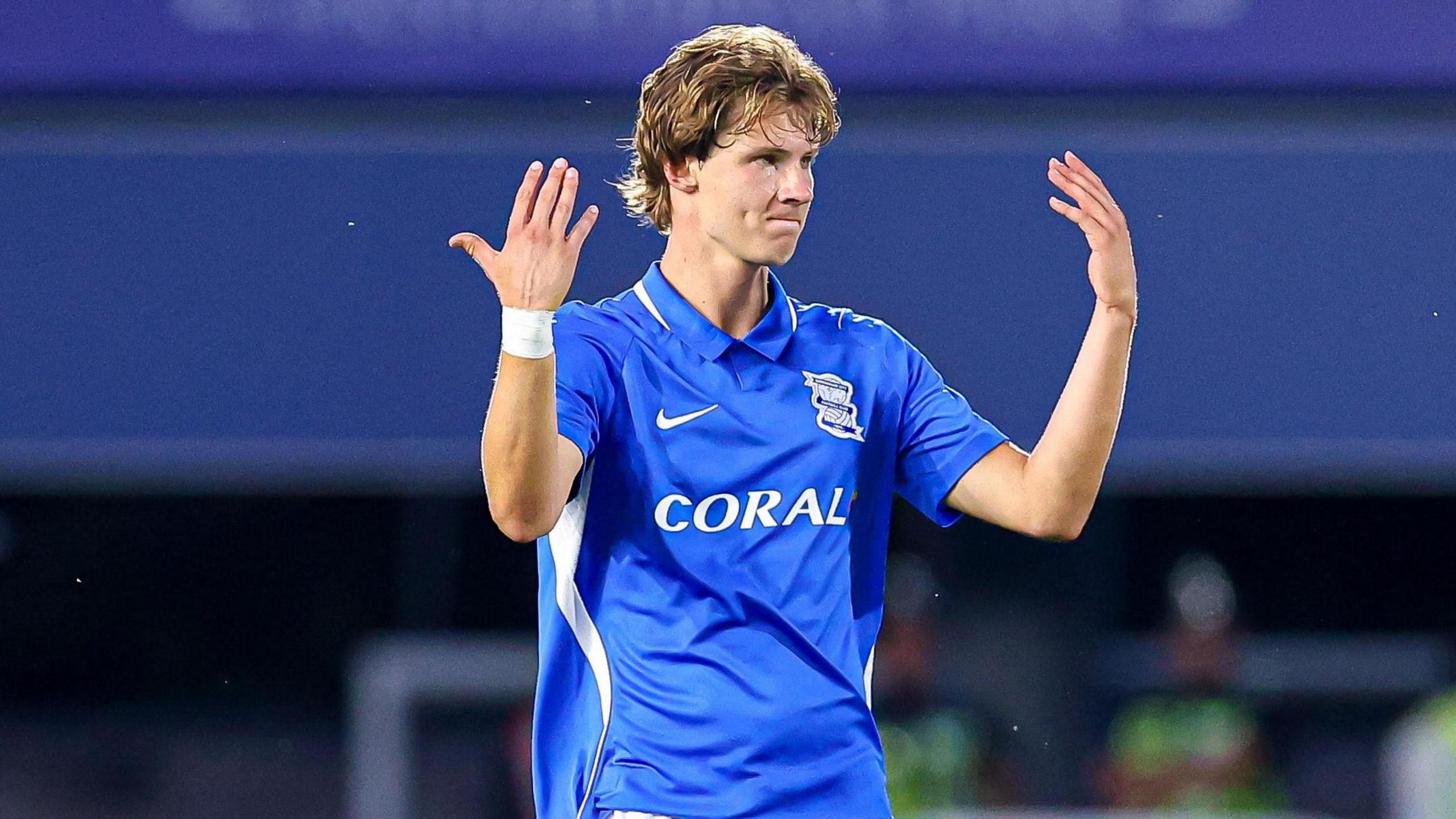 August Priske, the Birmingham City striker, raises his hands while wearing a blue shirt during the pre-season friendly with Barcelona