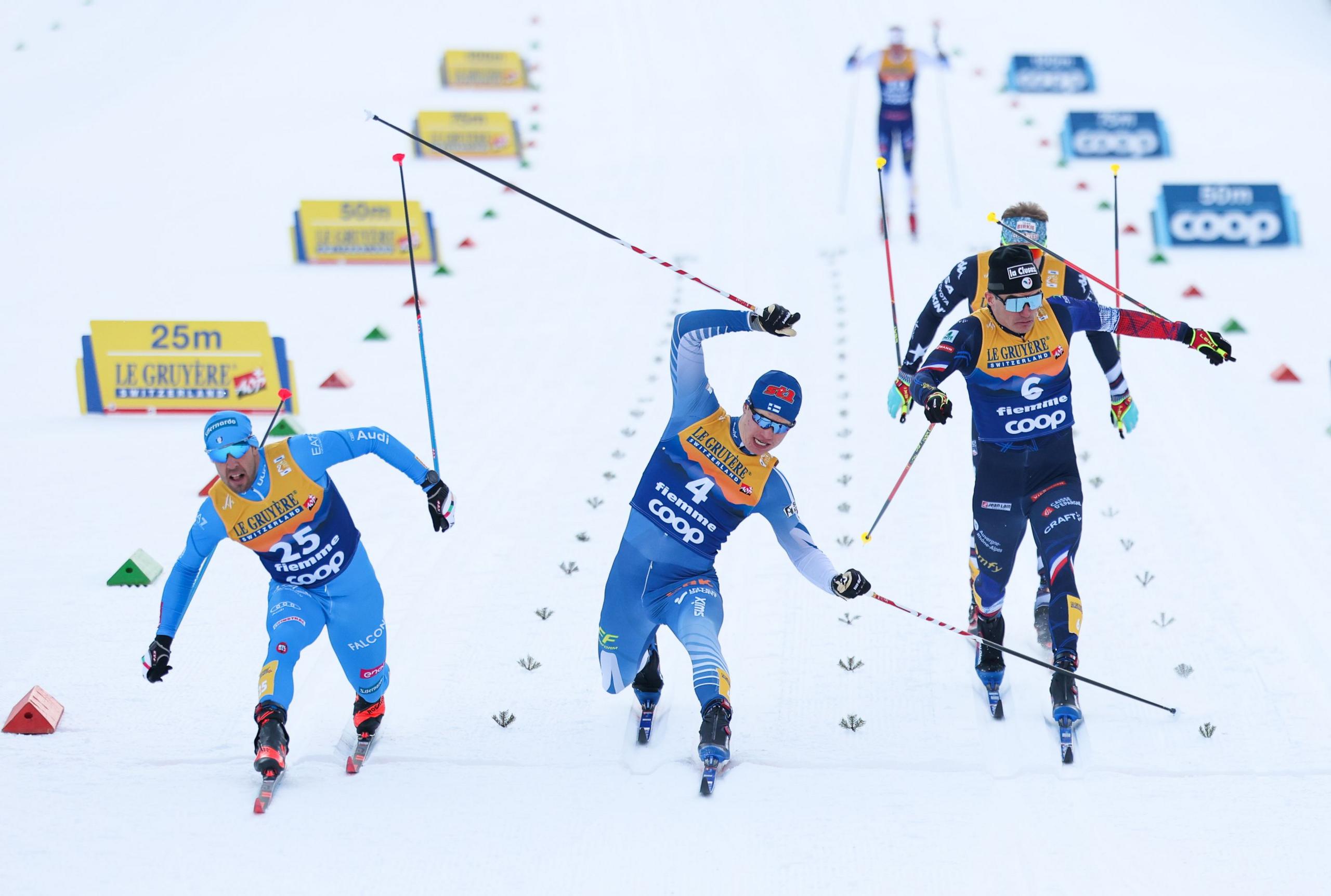 Italy's Federico Pellegrino, left, crosses the finish line in second place before Finland's Niilo Moilanen in the quarter-finals of the Men's Individual Sprint Final Classic of the FIS World Cup Cross-Country Val di Fiemme, part of the Tour de Ski, in Val di Fiemme, Italy. Photo by Alex Pantling