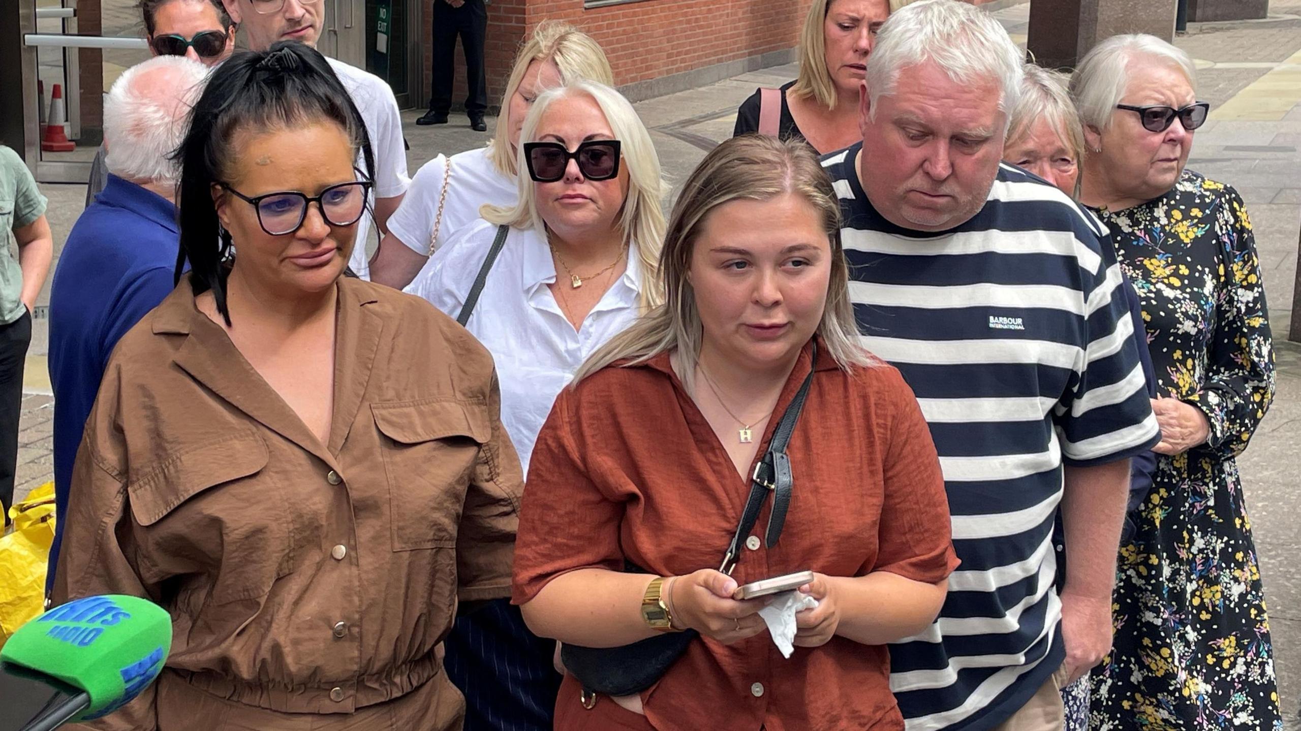 Harvey's sister Sophie Willgoose (centre) read a statement with her parents Caroline (left) and Mark Willgoose outside Sheffield Crown Court