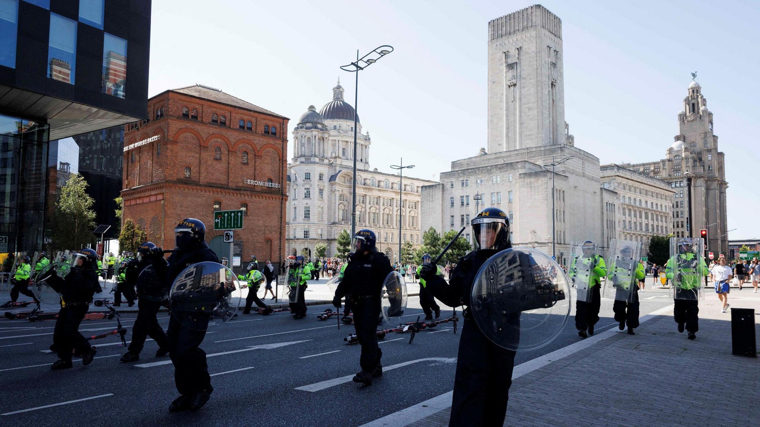 Riot police with shields and batons on the Pier Head