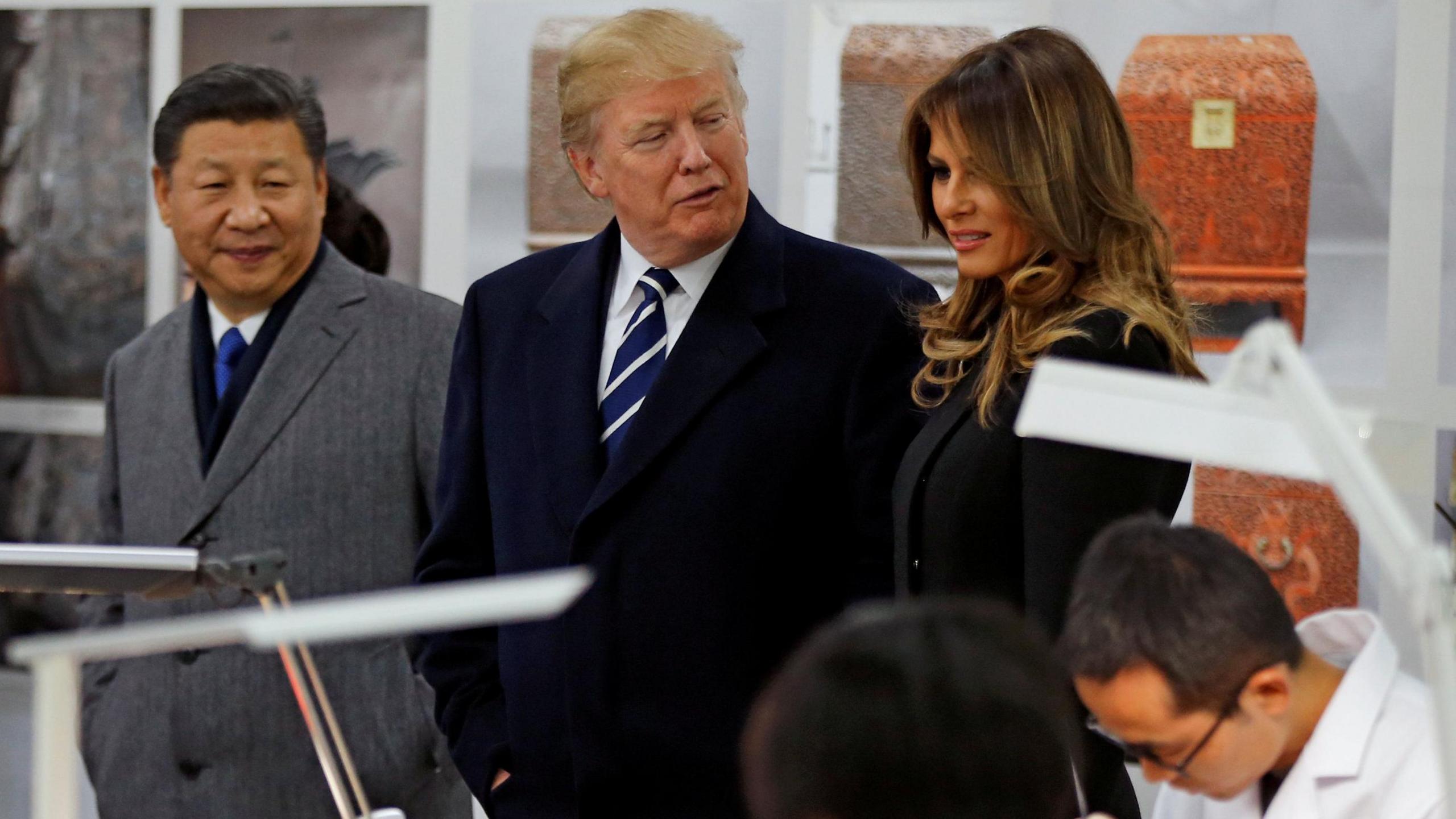 US President Donald Trump chats with first lady Melania Trump as they tour the Conservation Scientific Laboratory of the Forbidden City with Chinese President Xi Jinping