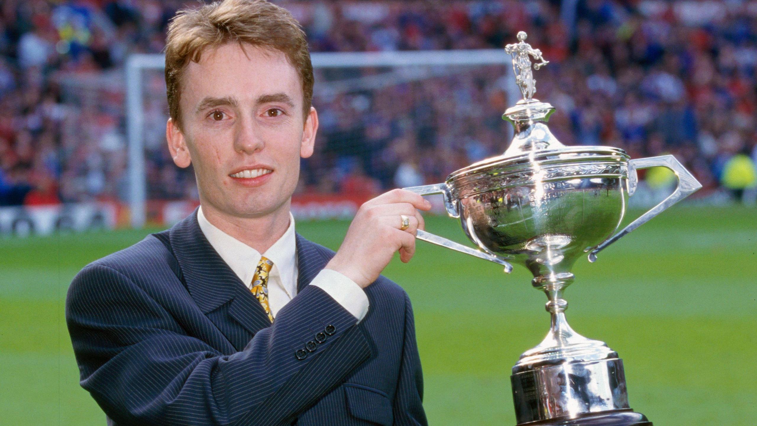 Ken Doherty holds the world snooker championship trophy