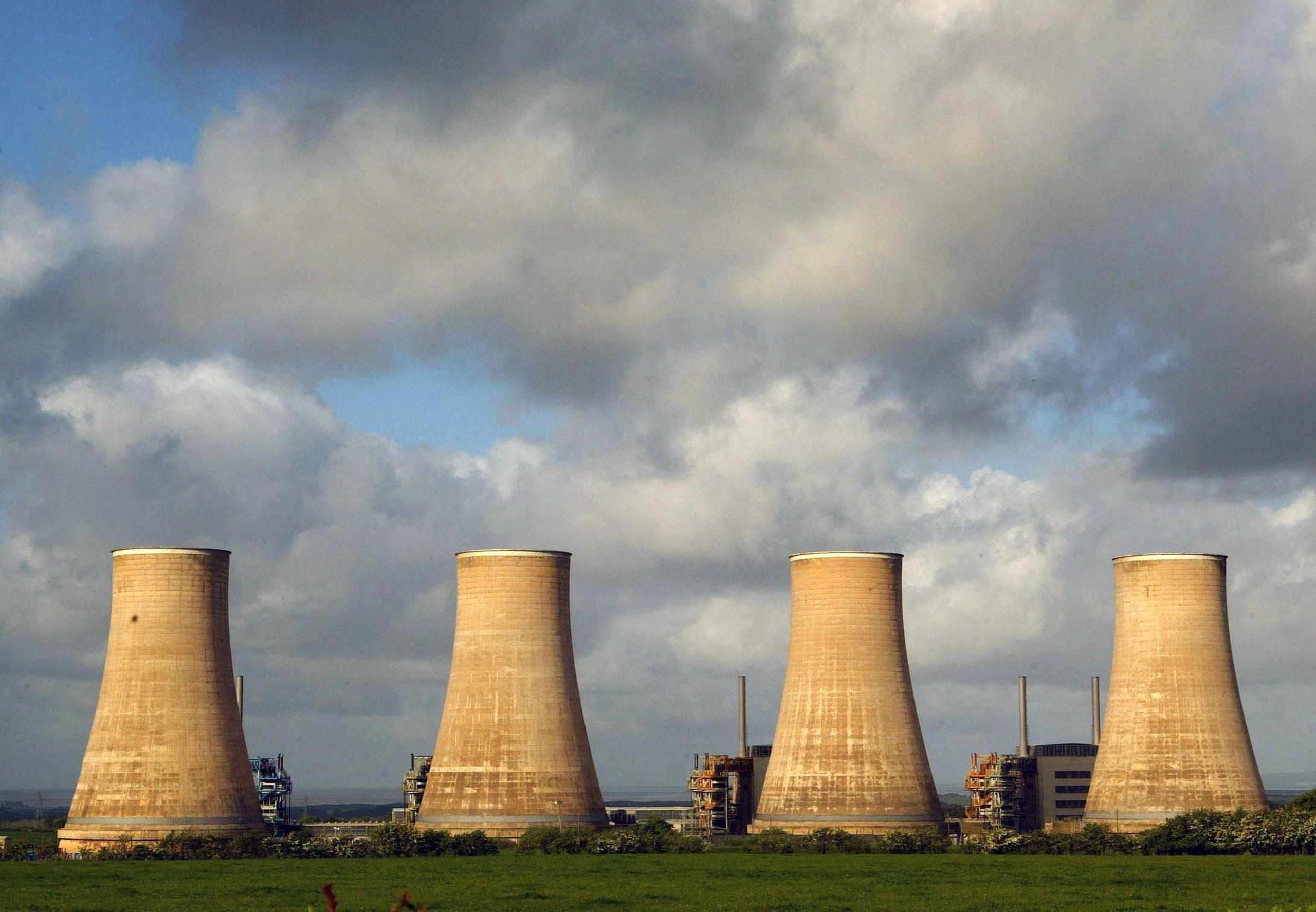 Four large chimneys sit in the south of Scotland landscape beneath ominous grey clouds