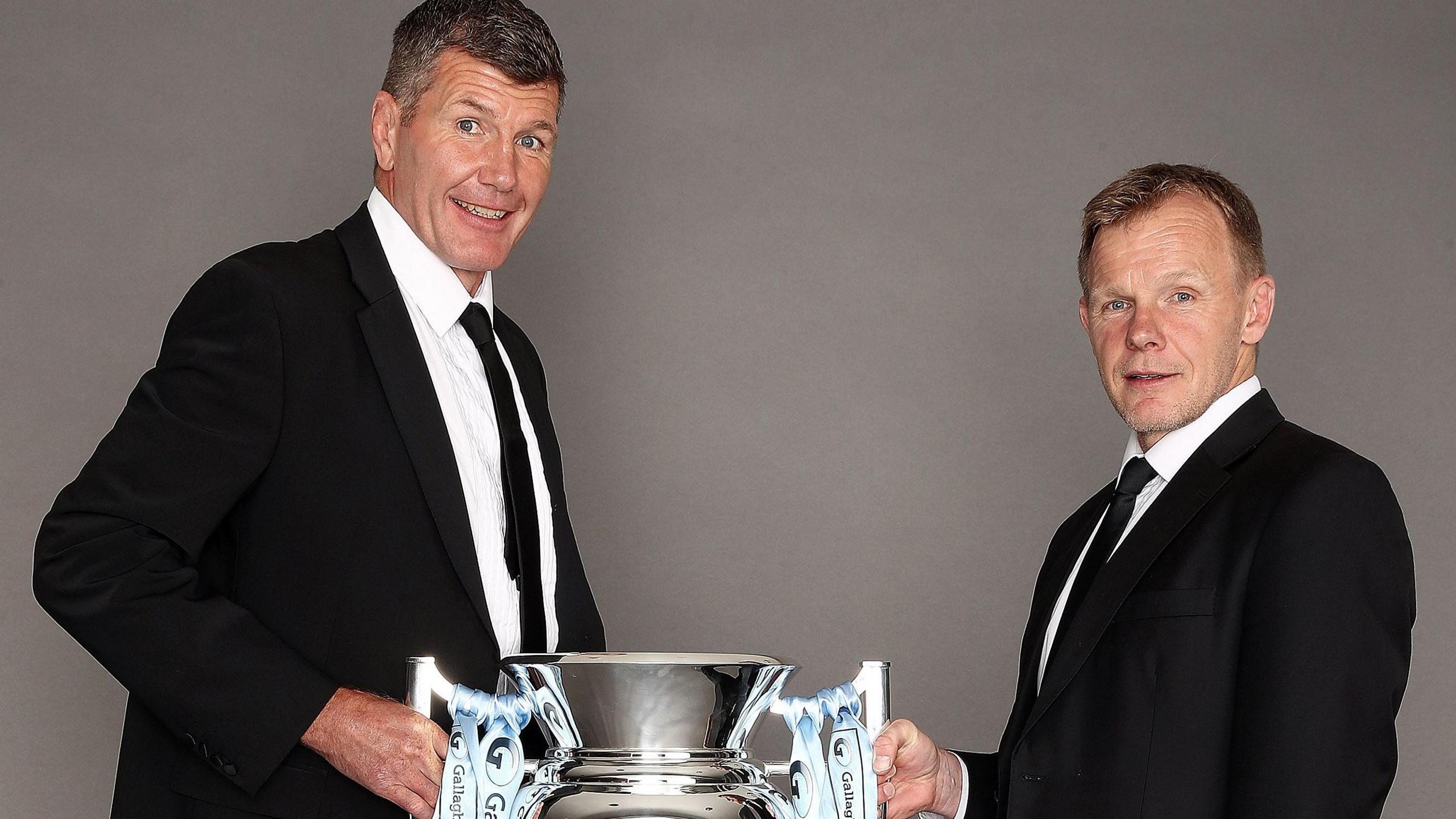 Exeter's Rob Baxter (left) and Saracen's Mark McCall pose with the Prem trophy