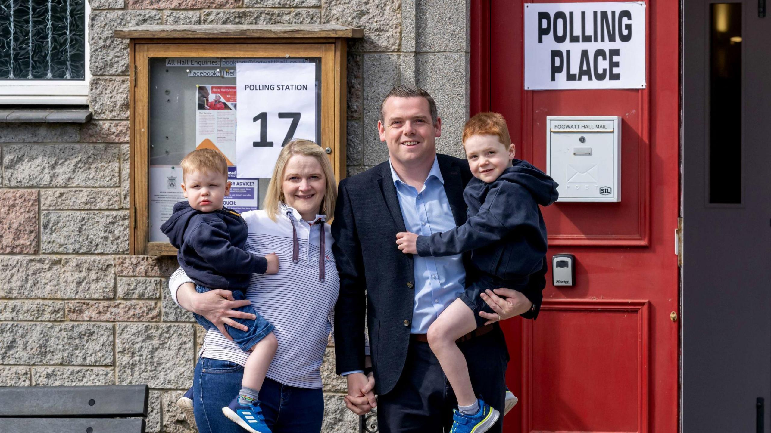 Scottish Conservative leader Douglas Ross and his family entering a polling station at the general election