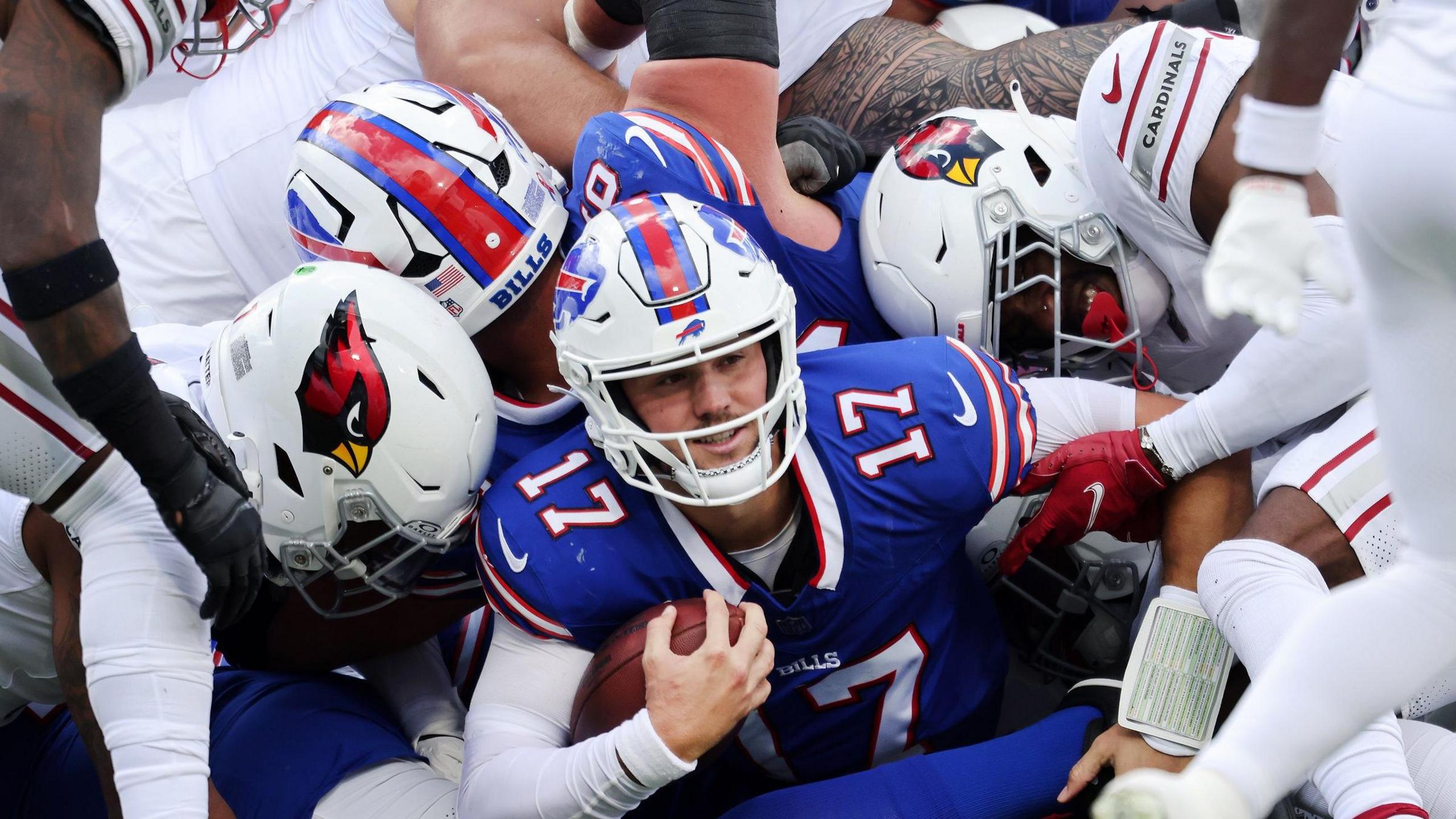 Buffalo Bills quarterback Josh Allen under a pile of bodies during the game against Arizona