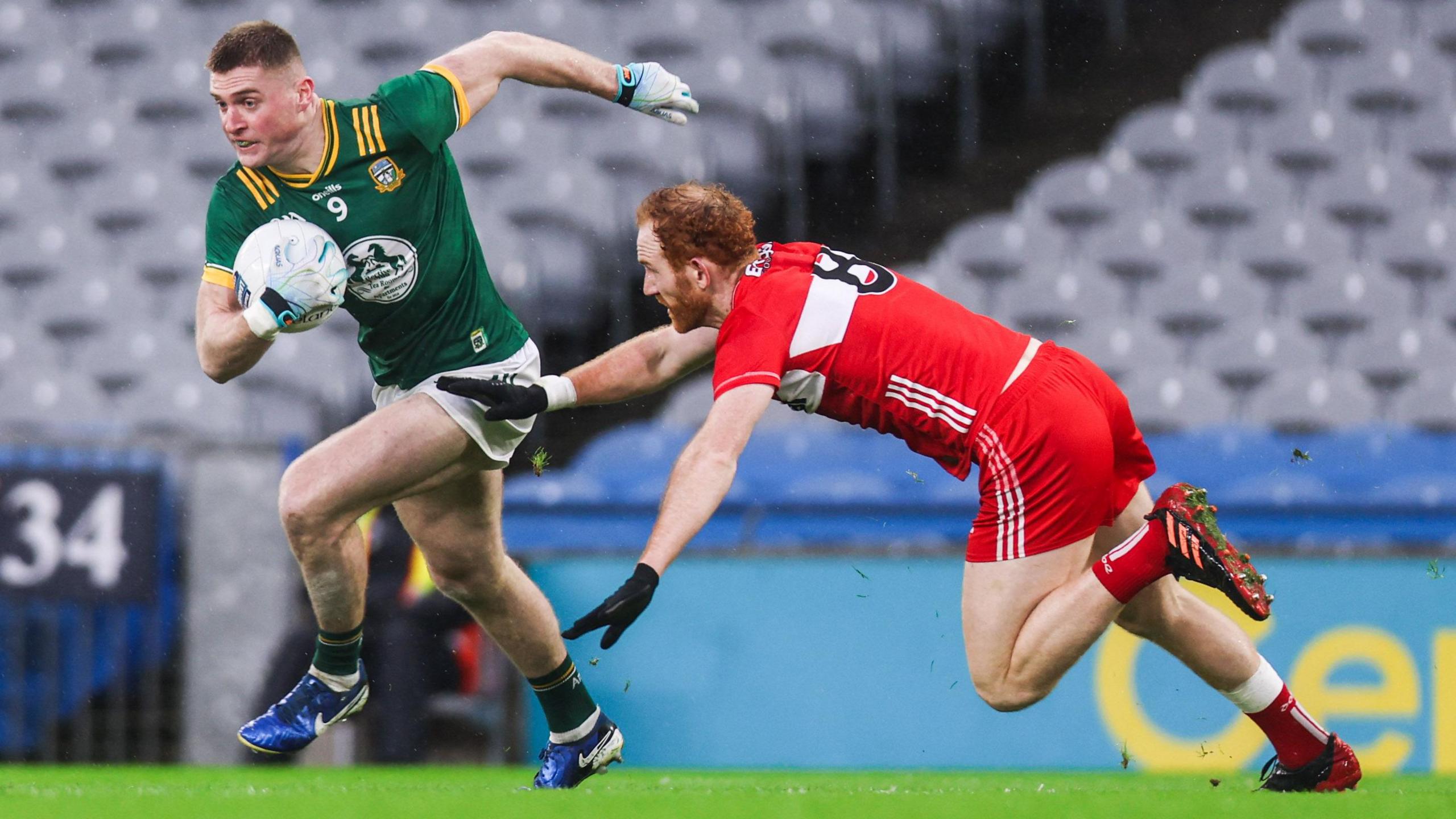 Meath's Jack Flynn gets away from Conor Glass