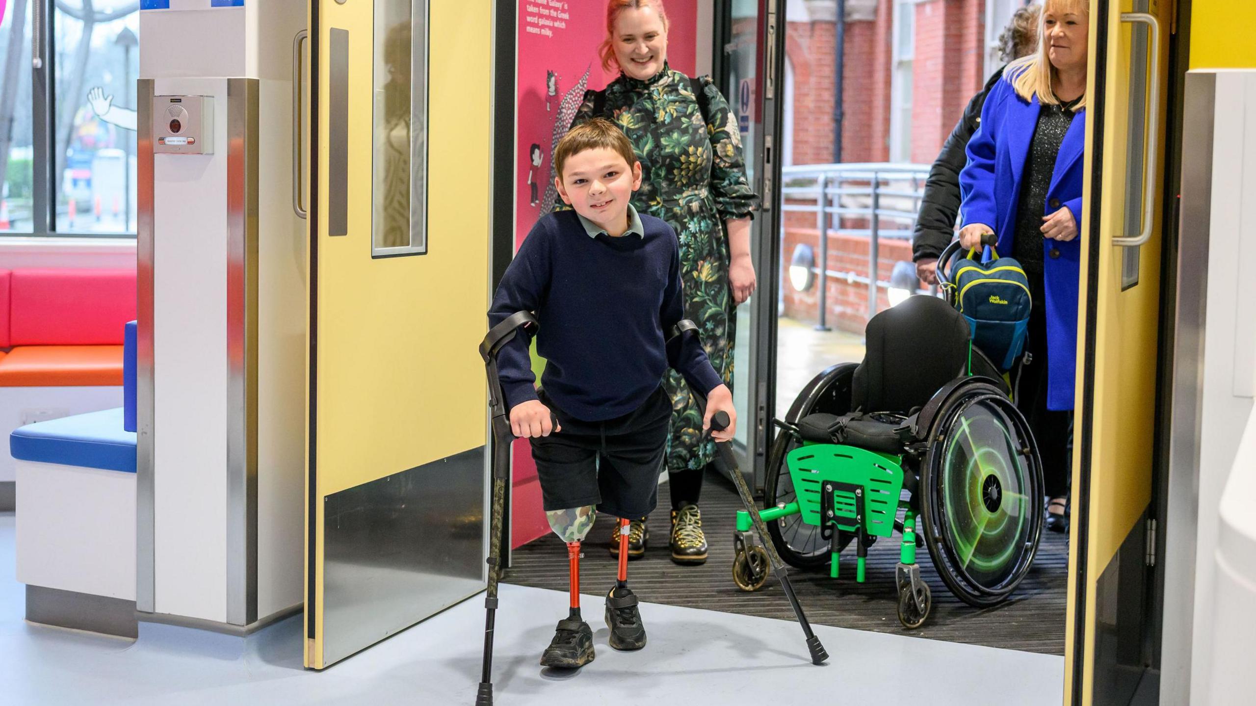 Tony Hudgell and his adopted mother Paula walking through hospital doors