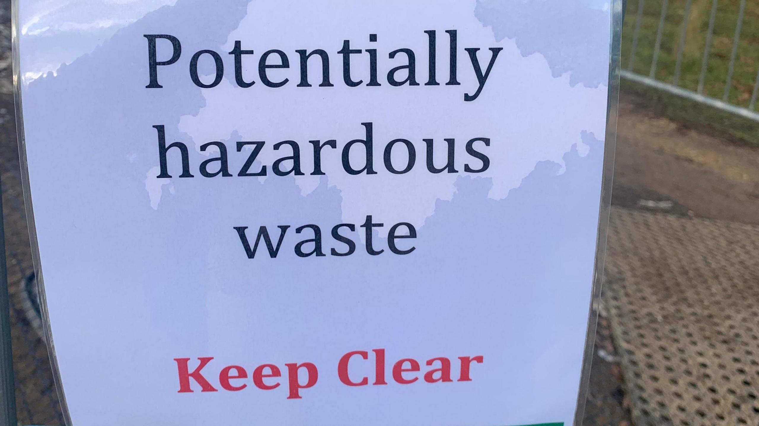 A sign warning people to keep clear of the waste