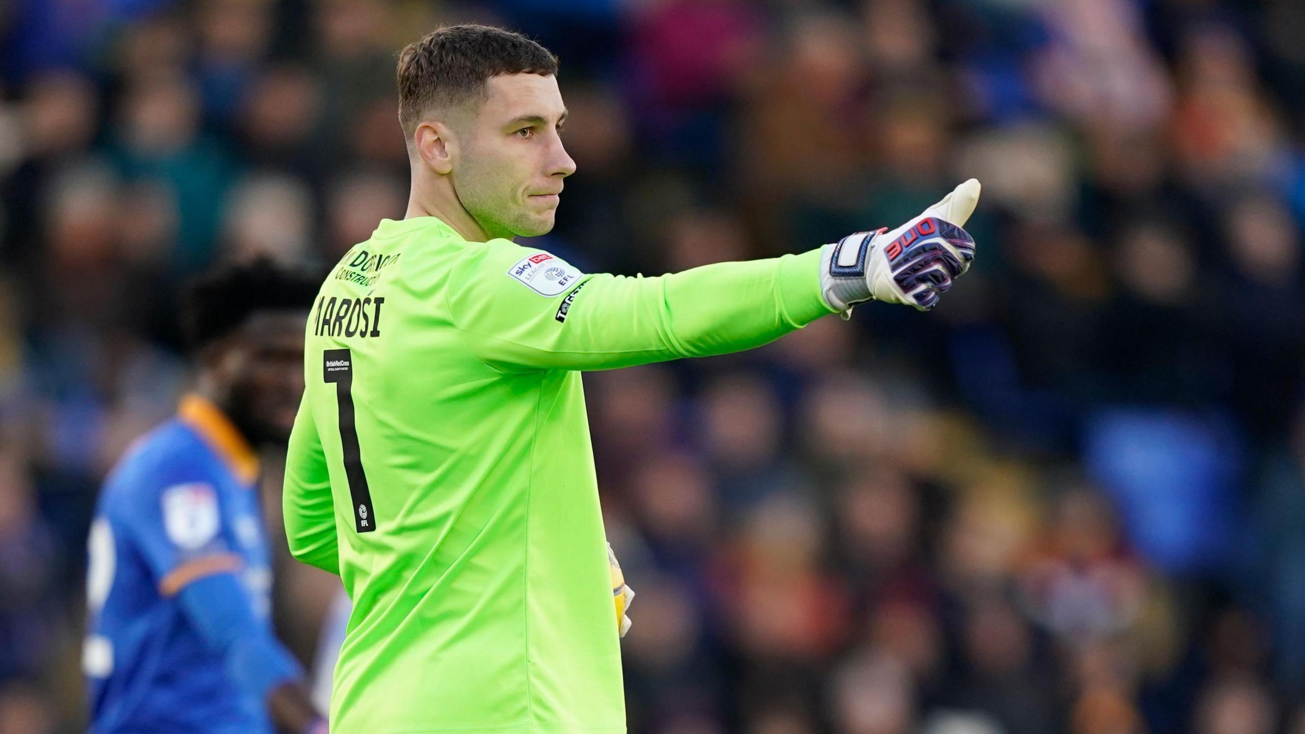 Shrewsbury Town goalkeeper Marko Marosi gives a thumbs up to his defence during a game