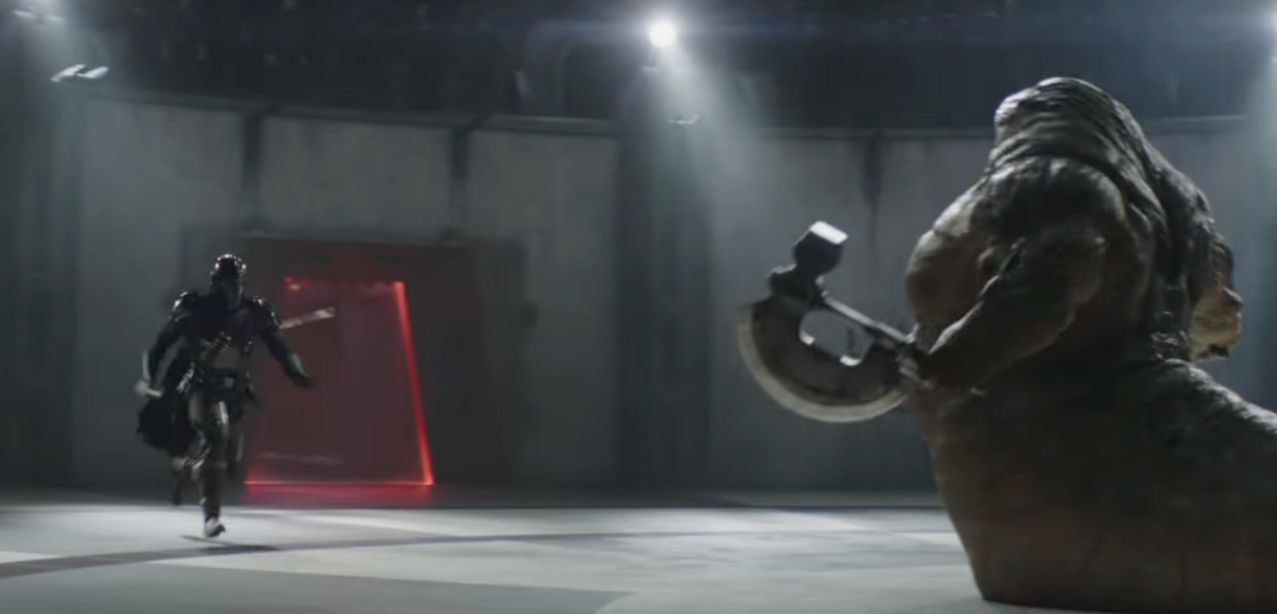 The Mandalorian runs at a muscular slug-alien known as a hutt in an arena. 