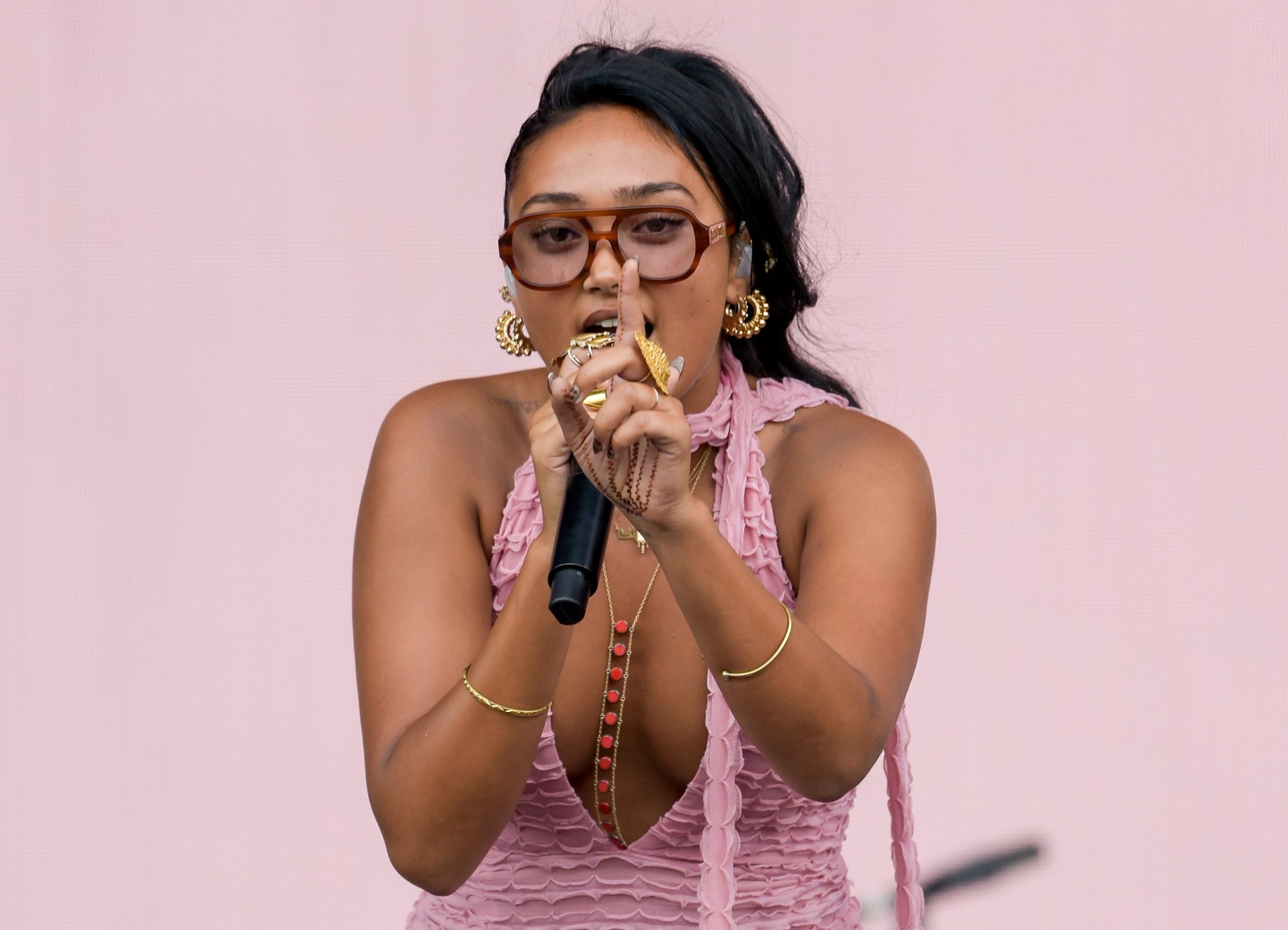 Joy Crookes holds a finger up to the camera as she performs on stage at the 2025 Reading Festival