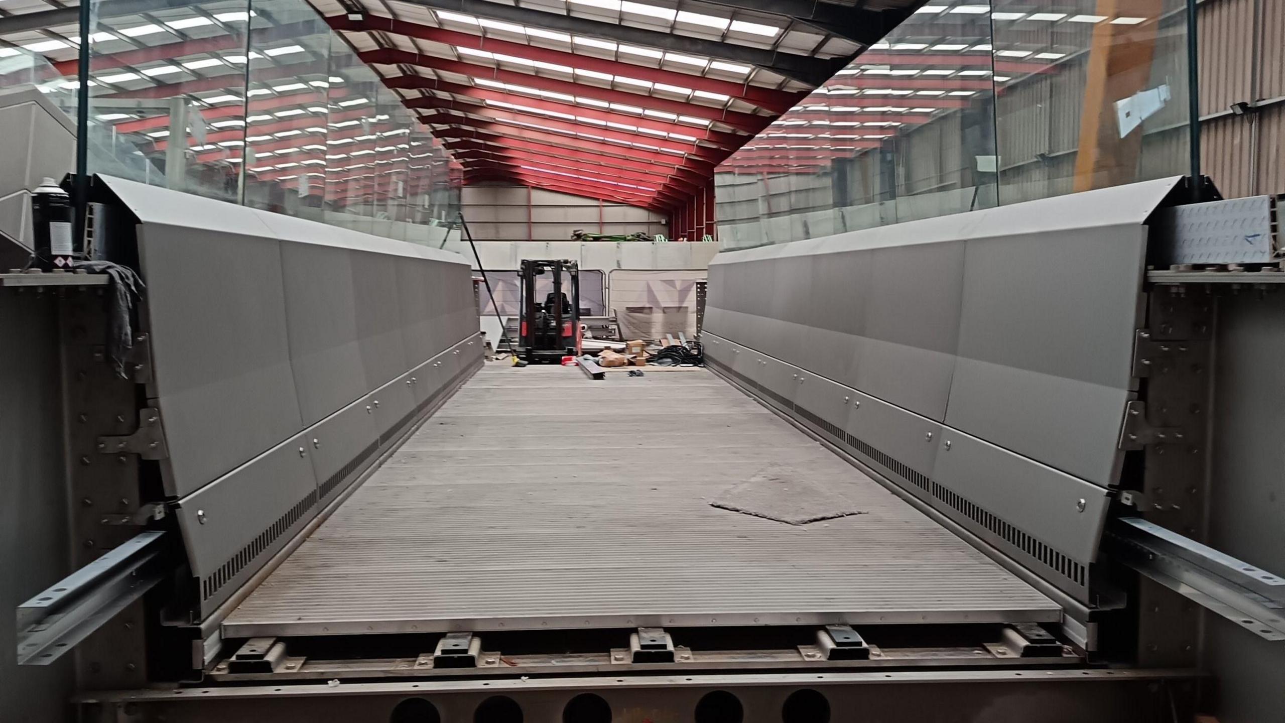 The top part of the new bridge inside a warehouse prior to it being installed.