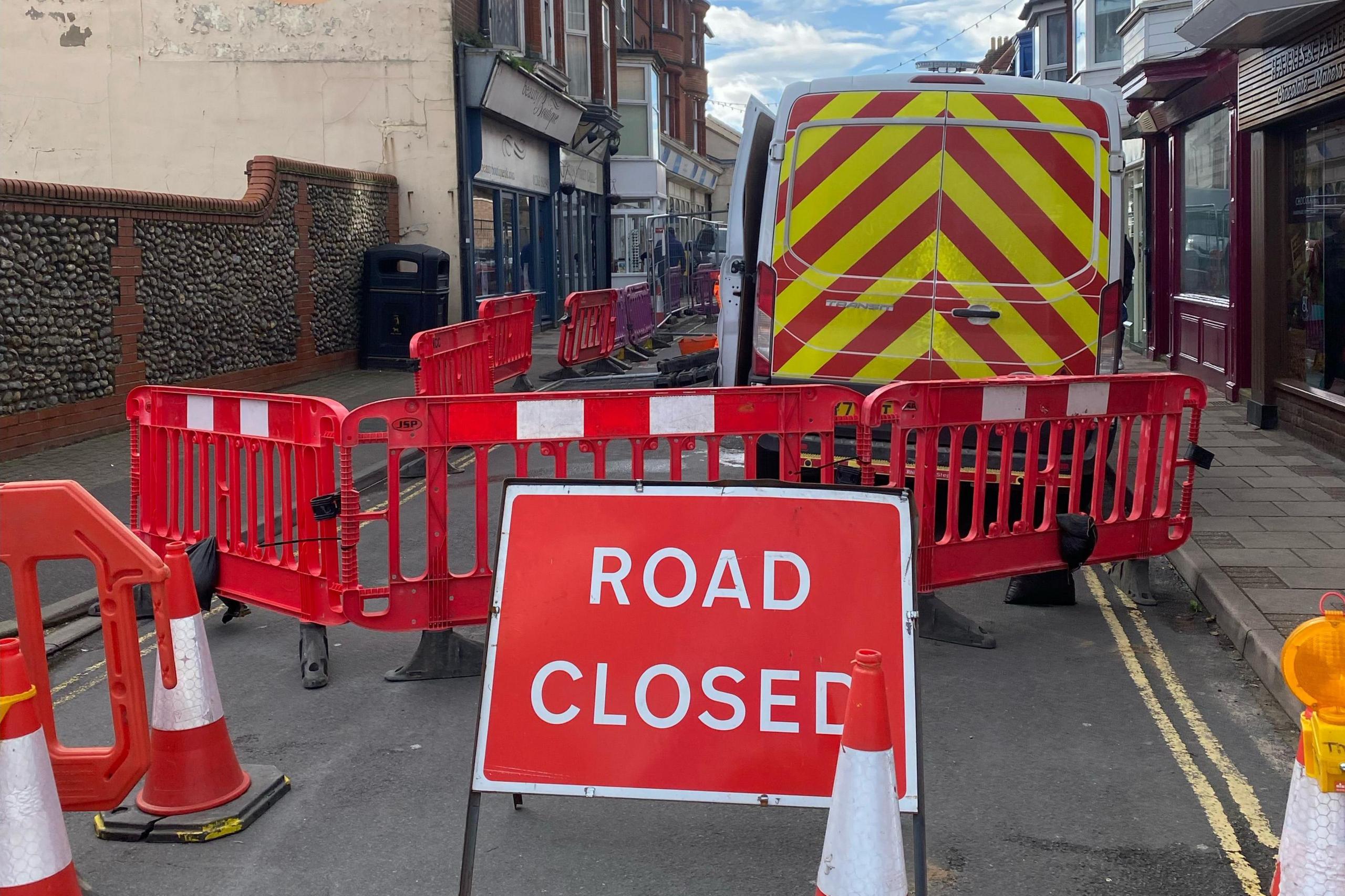 A 'road closed' sign by the sinkhole