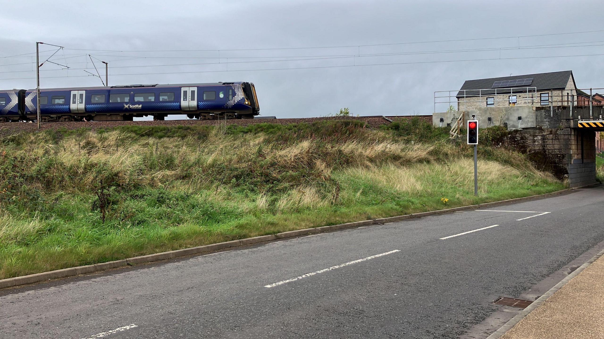 A train passes through the site of the new Balgray railway station in East Renfrewshire