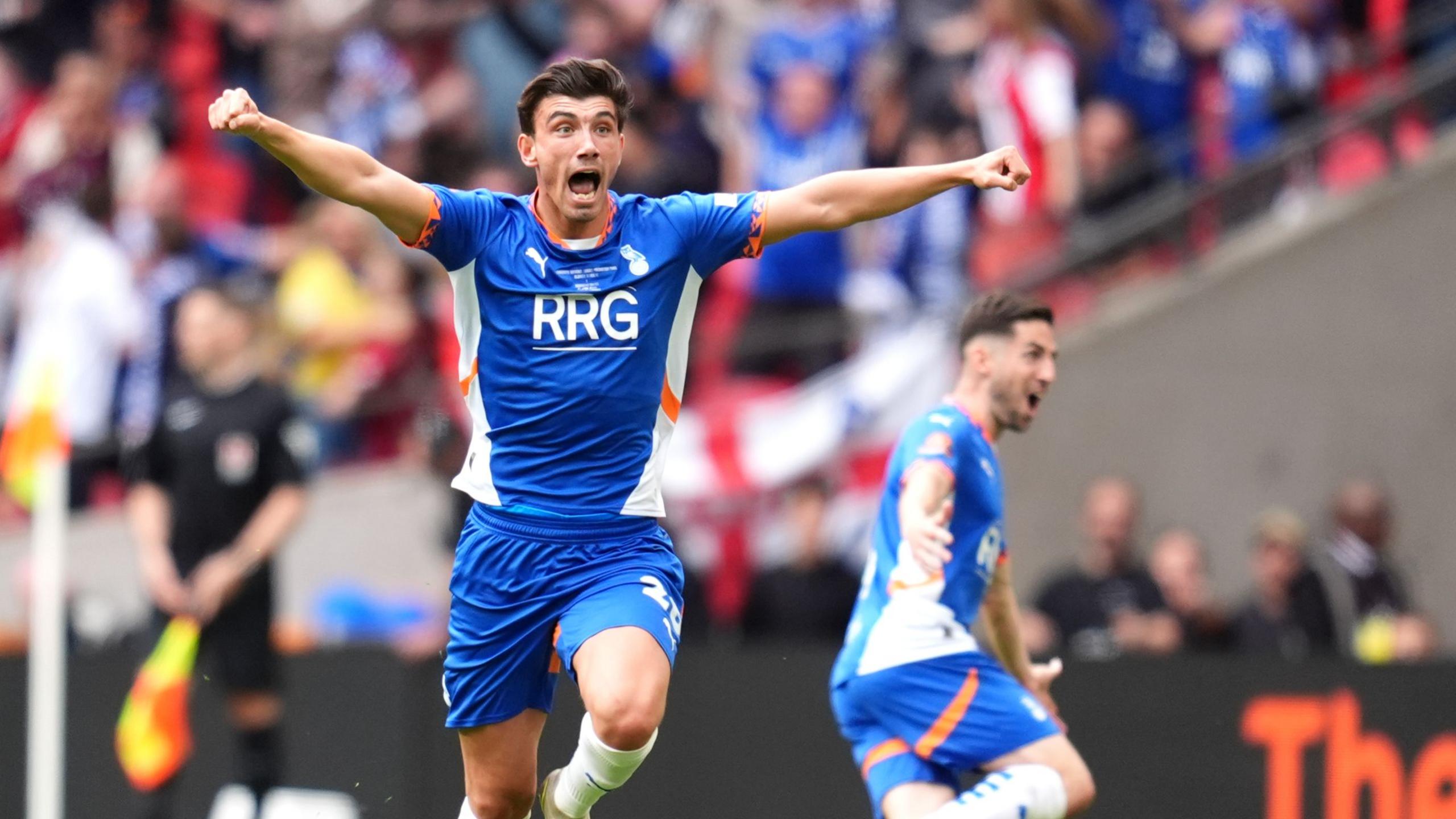 Oldham Athletic's Kian Harratt (left) celebrates scoring their side's third goal