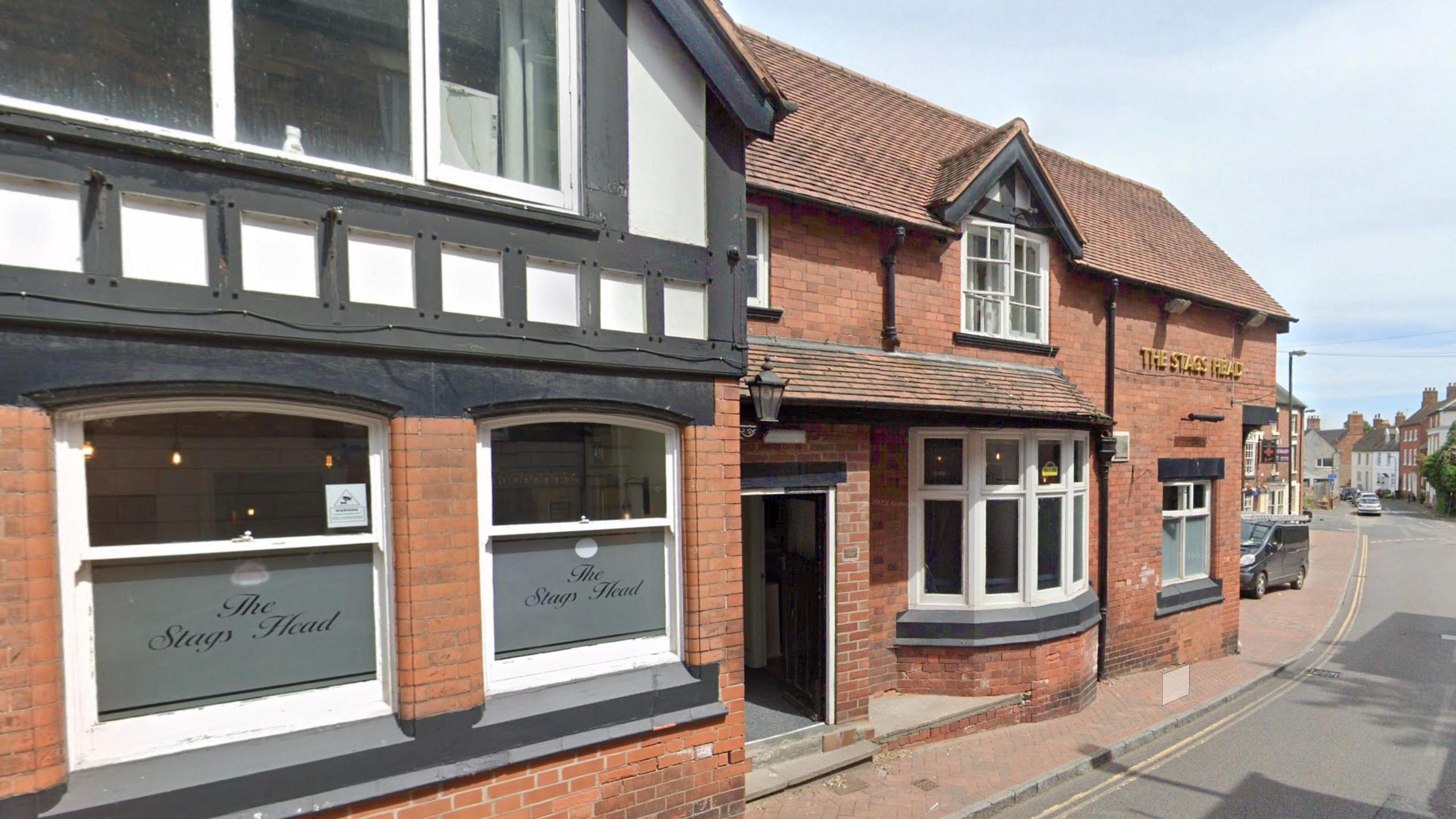 The front of a pub with a sign reading "the Stags Head"